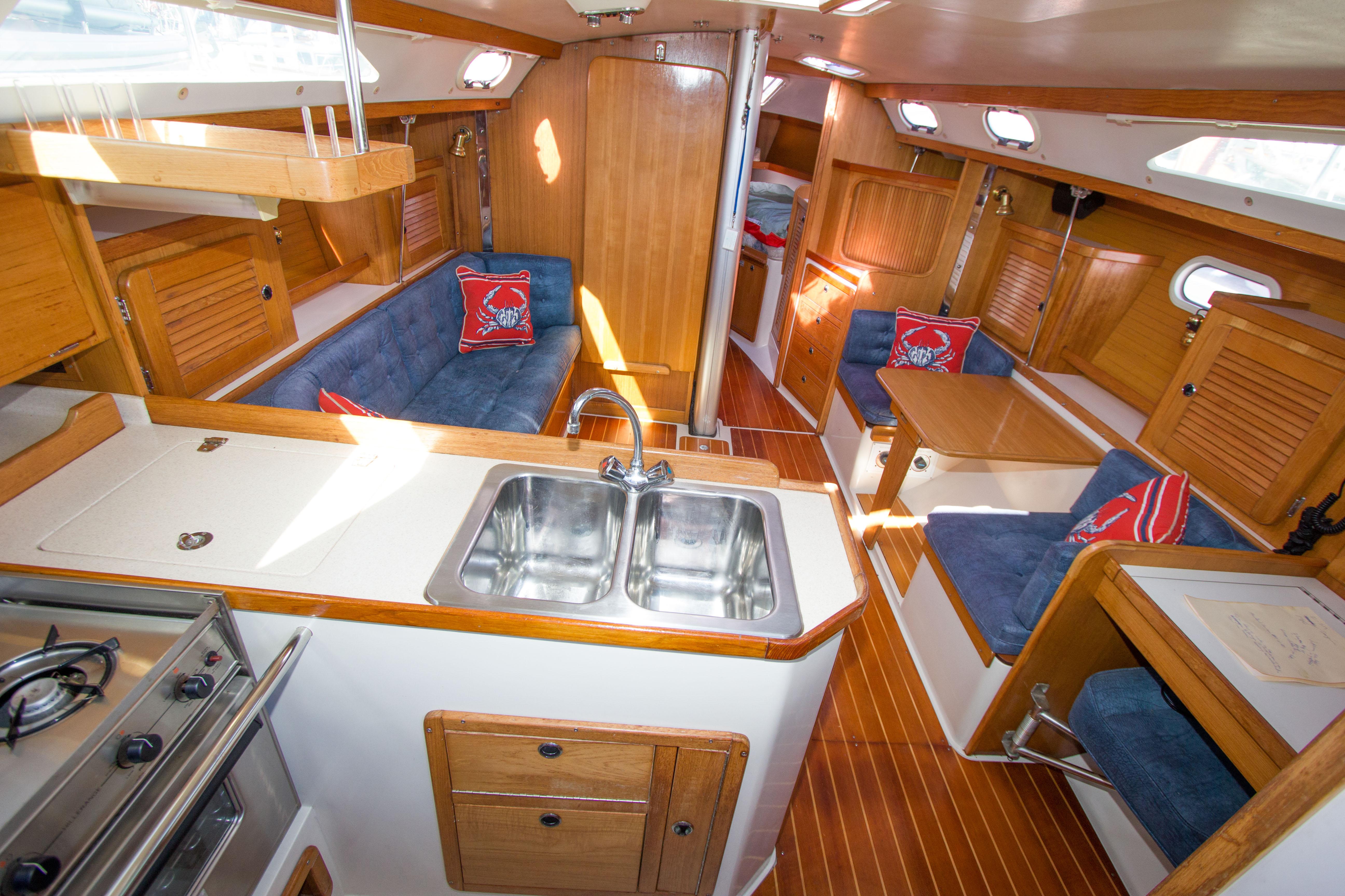Interior of 2001 Catalina MK II sailboat with wood finish and blue seating.