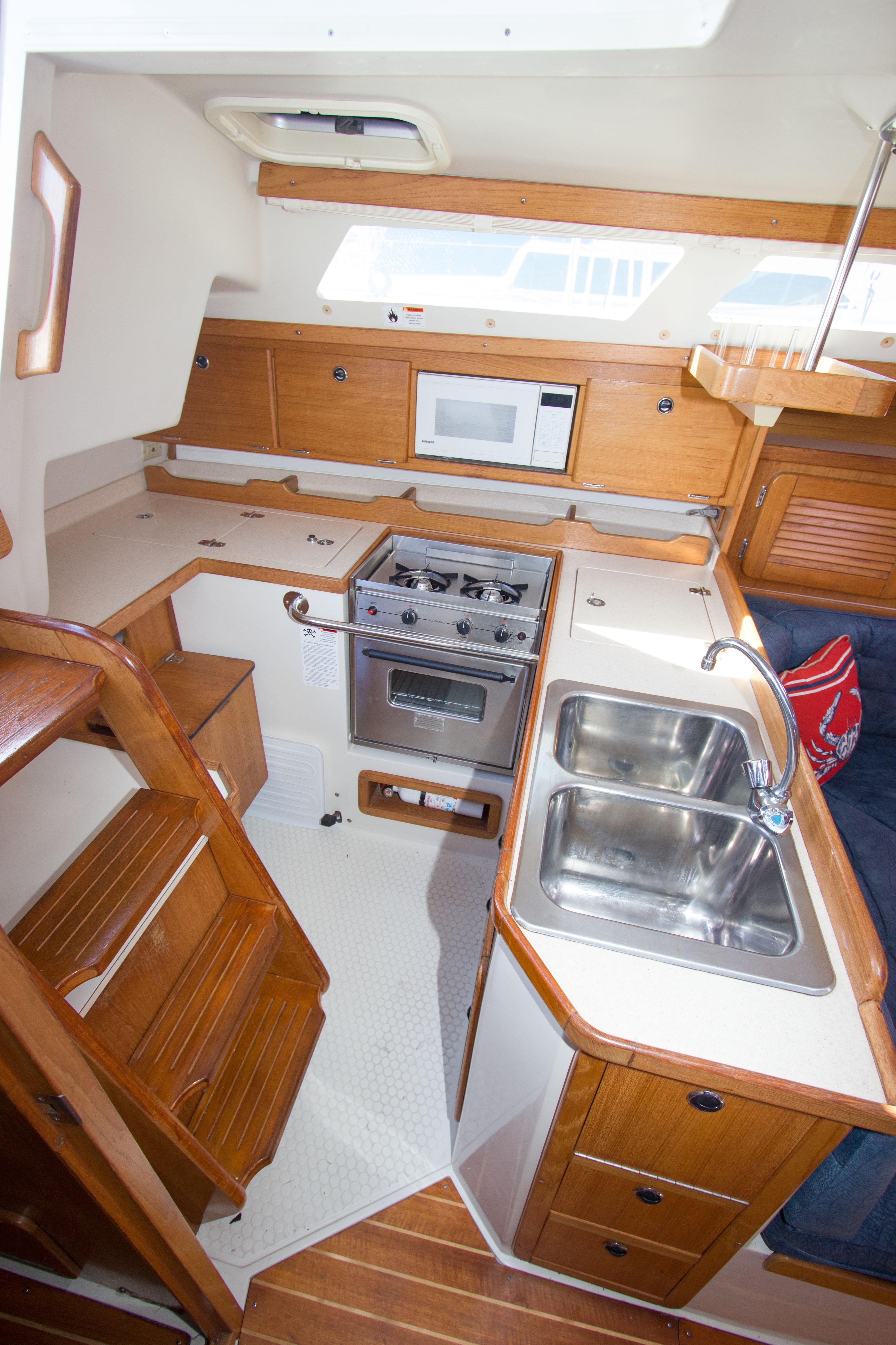 2001 Catalina MK II yacht kitchen with stove, sink, and microwave.
