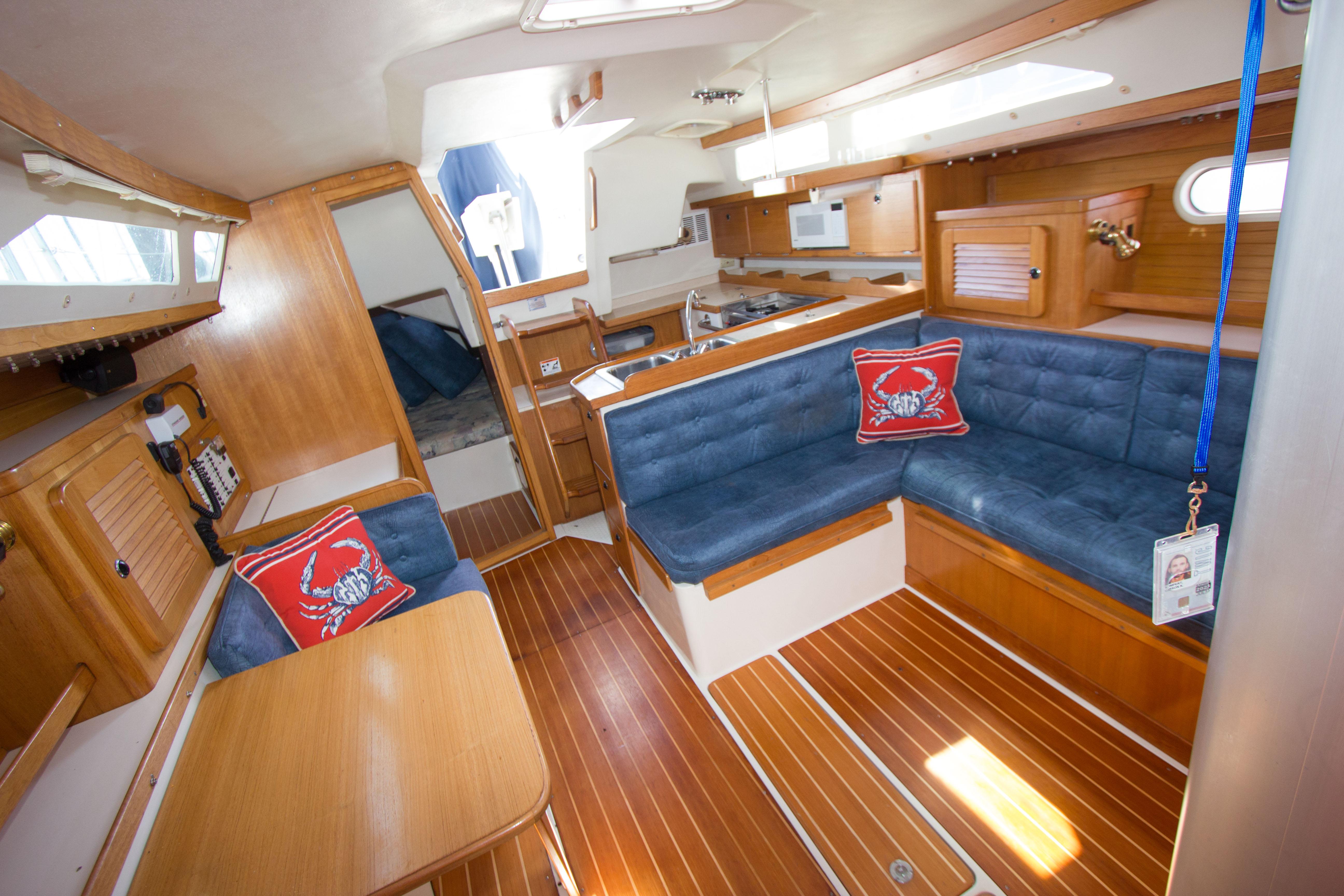 Interior of 2001 Catalina MK II sailboat with wooden finish and blue seating.