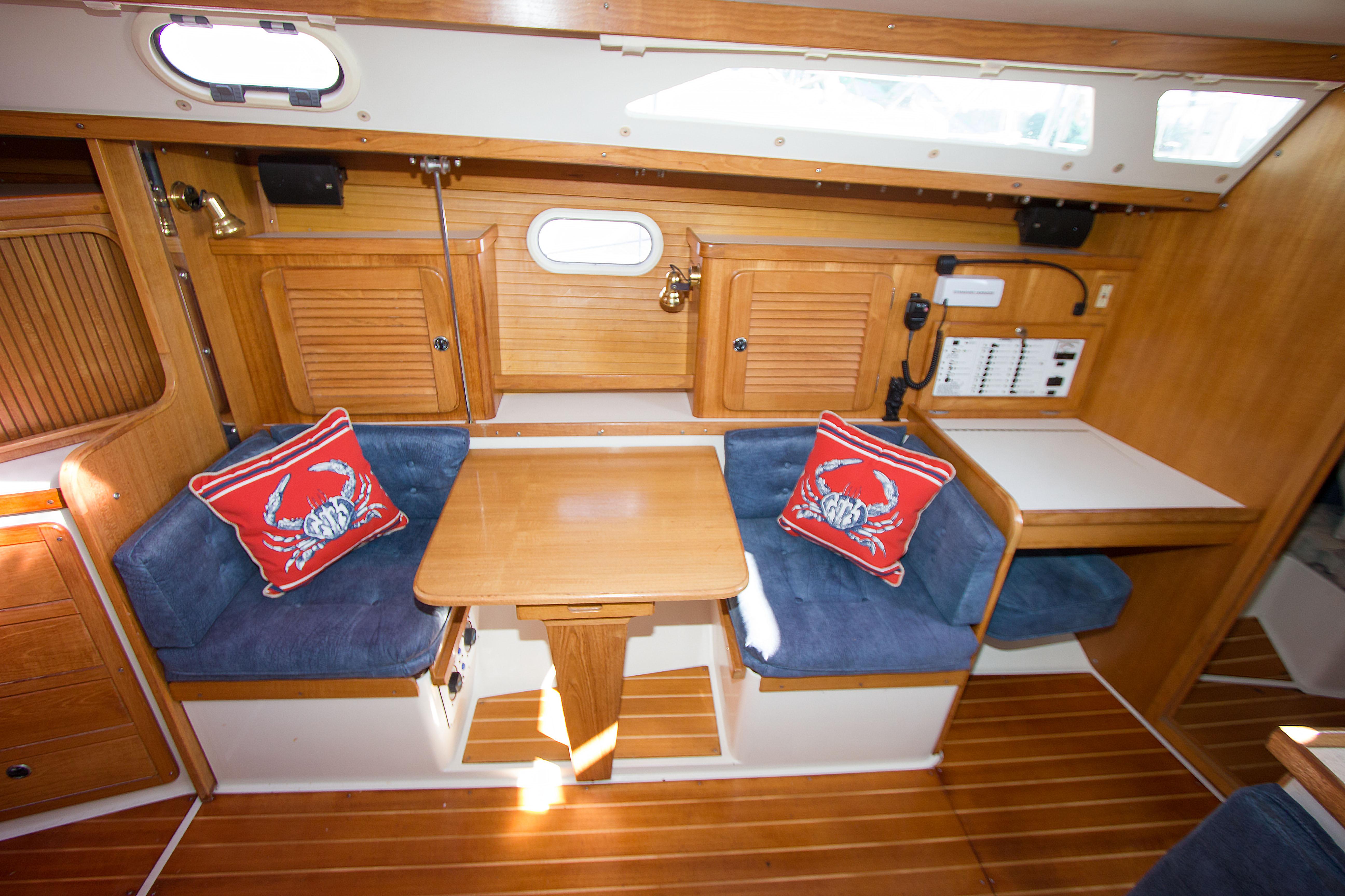 Interior of 2001 Catalina MK II sailboat with wooden finish and blue seating.