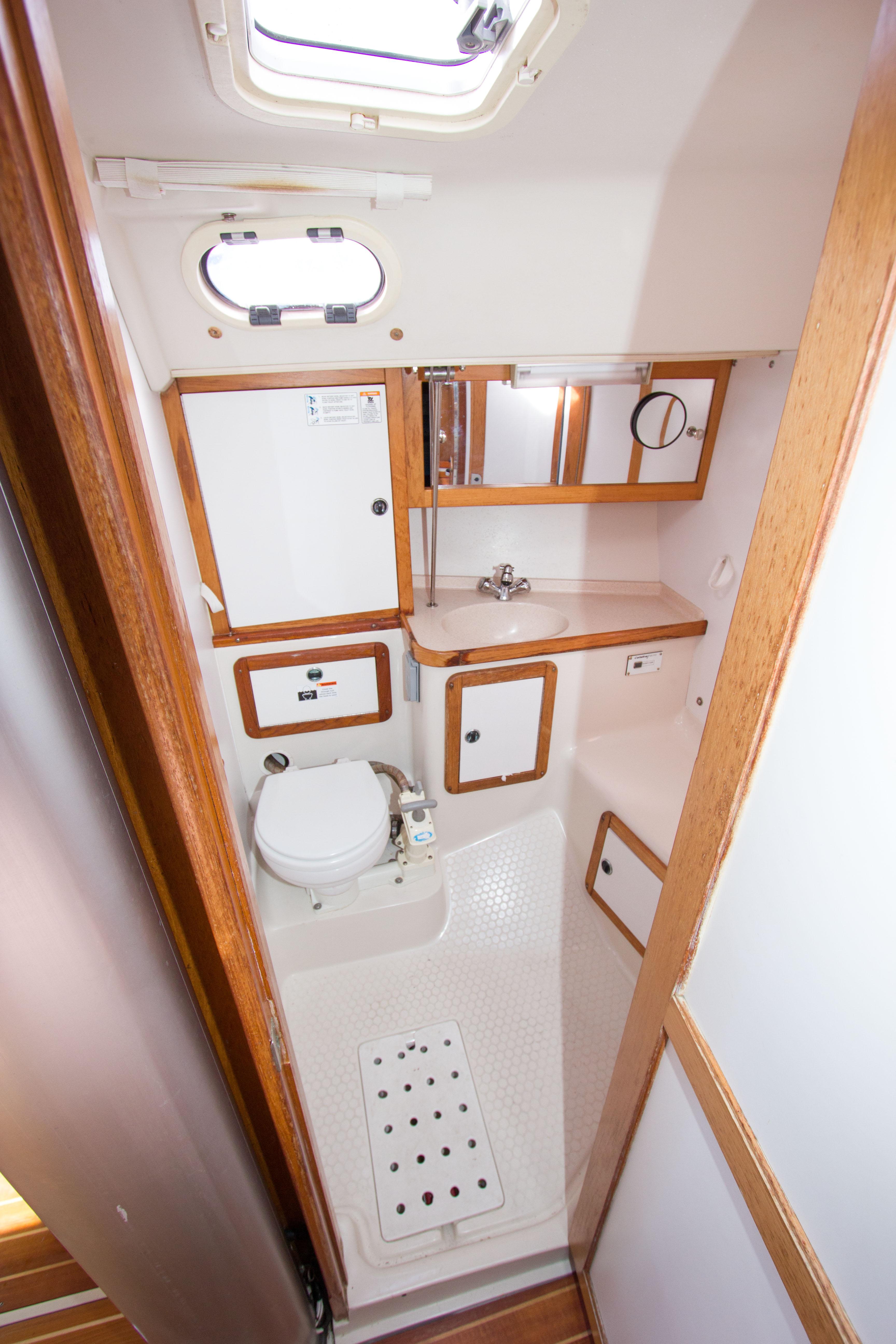 2001 Catalina MK II yacht bathroom with compact design, wooden accents, and essential amenities.