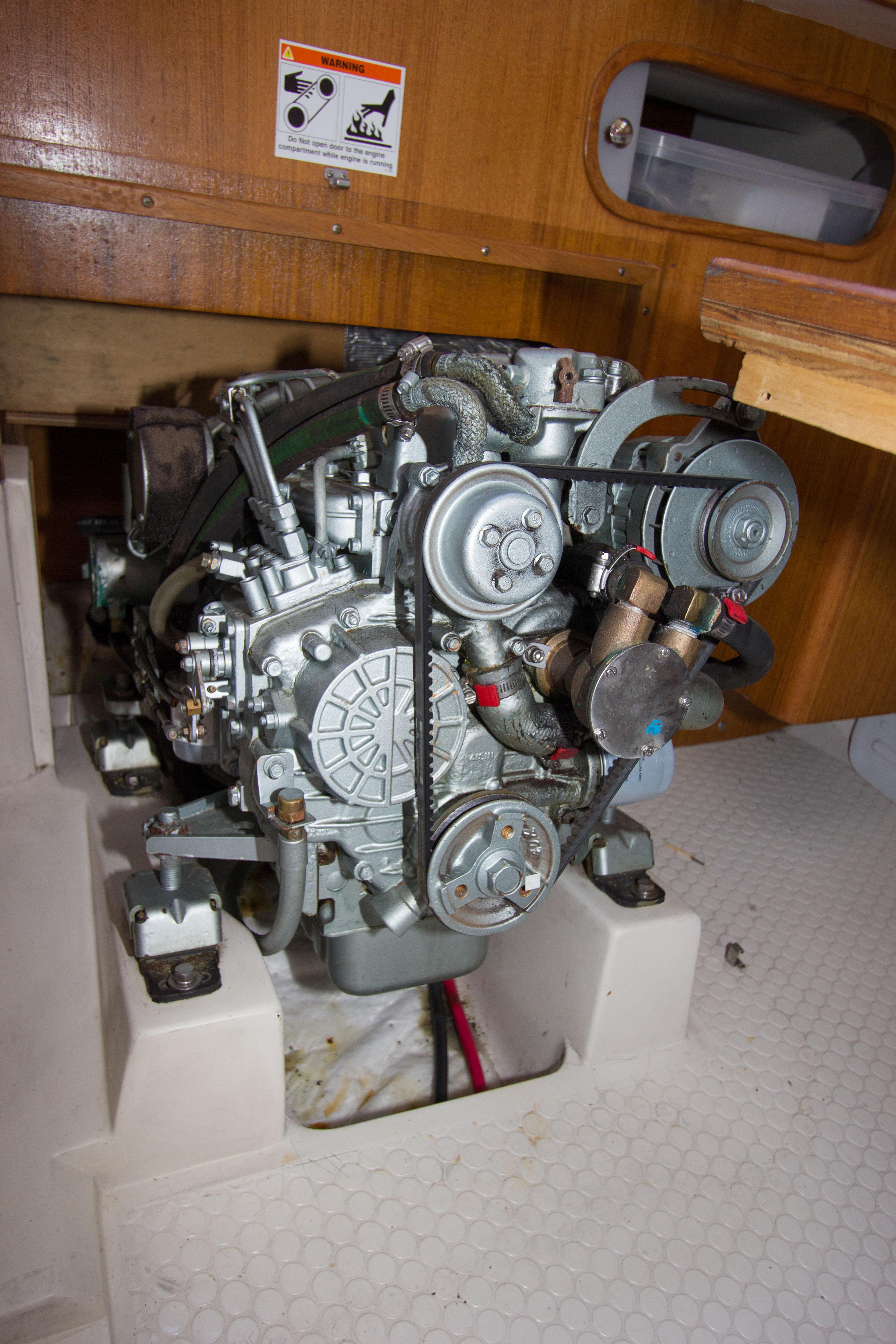 Engine of a 2001 Catalina MK II sailboat, showcasing mechanical components and wooden interior.
