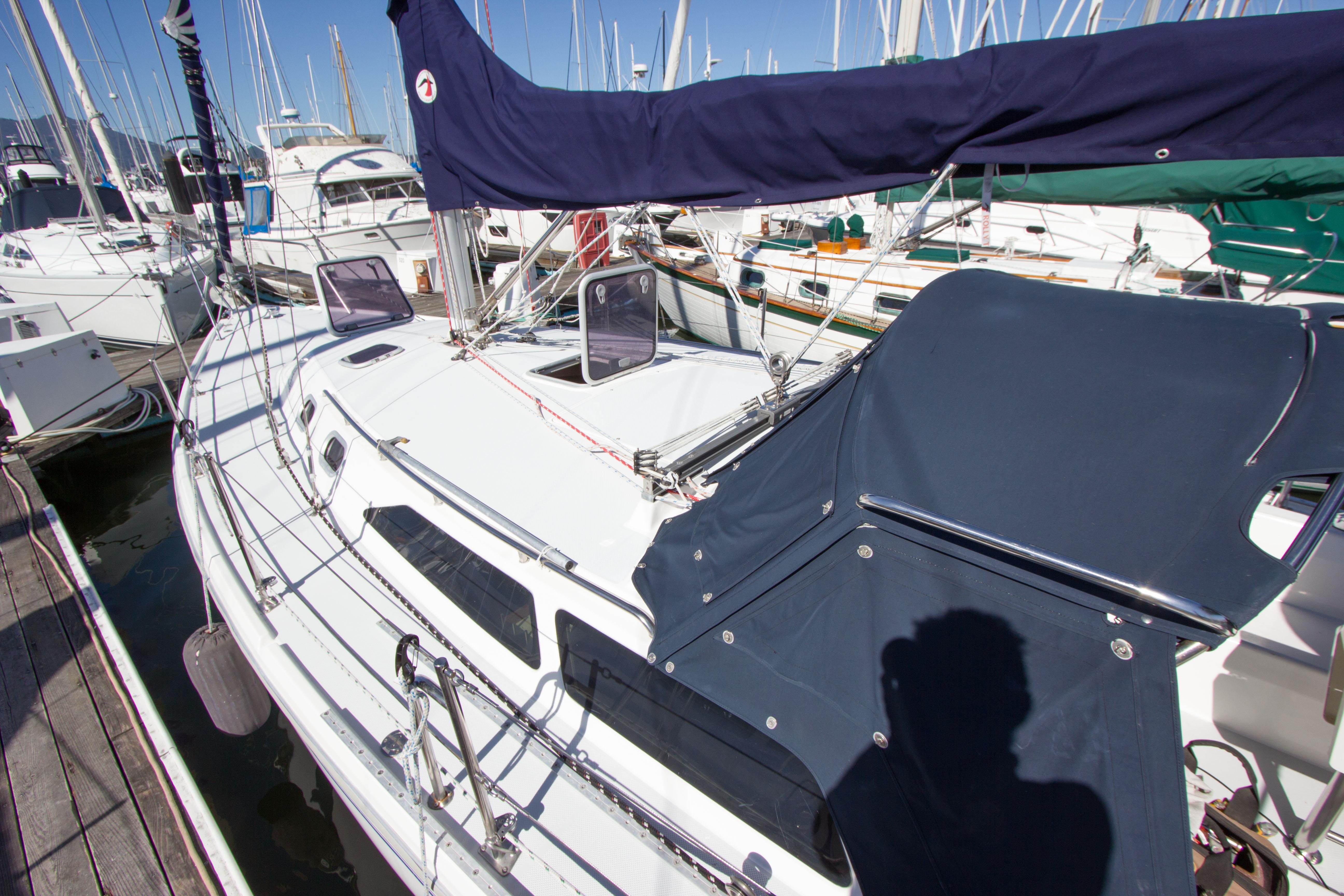 2001 Catalina MK II sailboat docked at marina, featuring sleek design and blue covers.