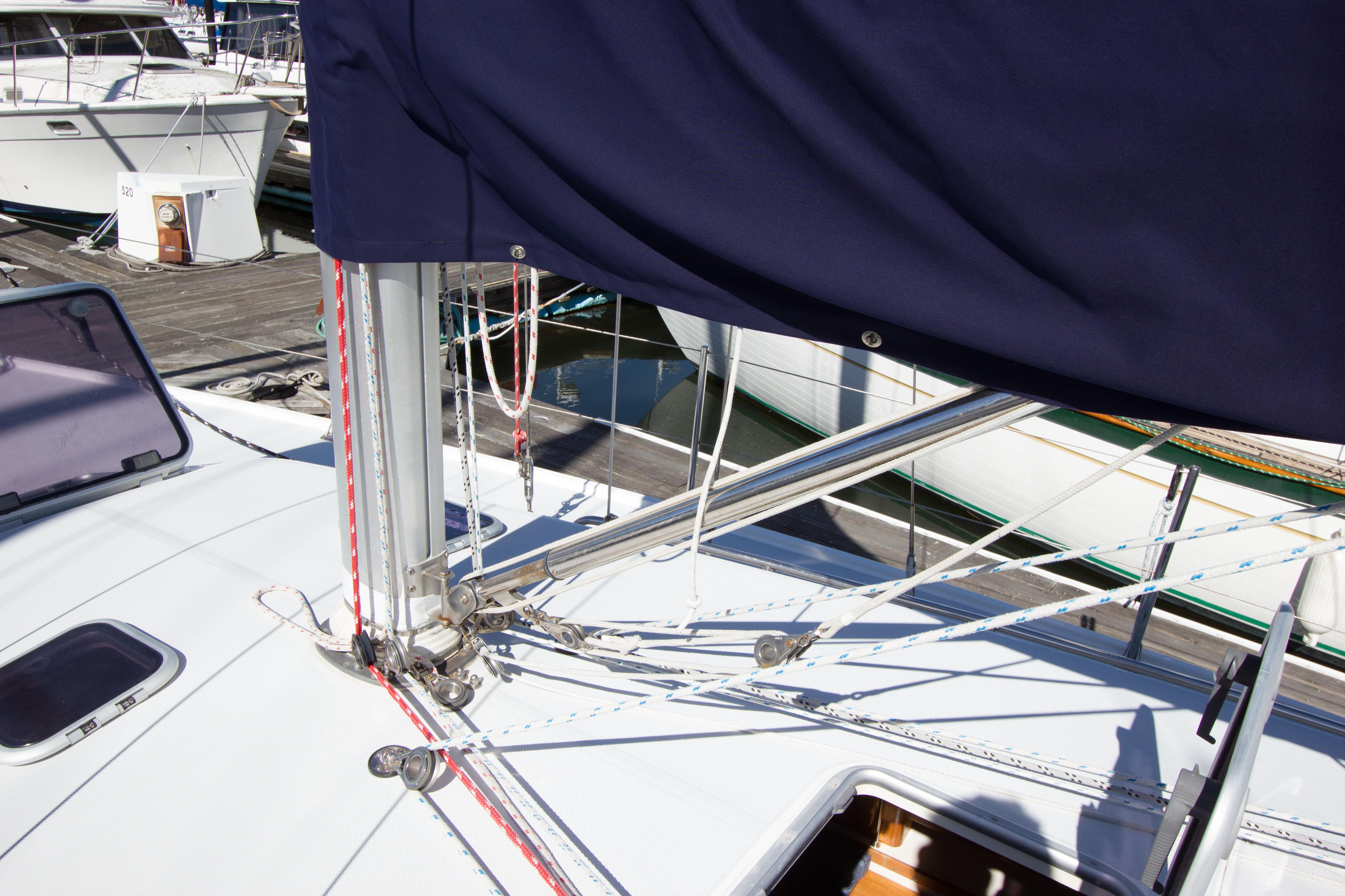 2001 Catalina MK II sailboat deck with rigging and covered mast at marina.