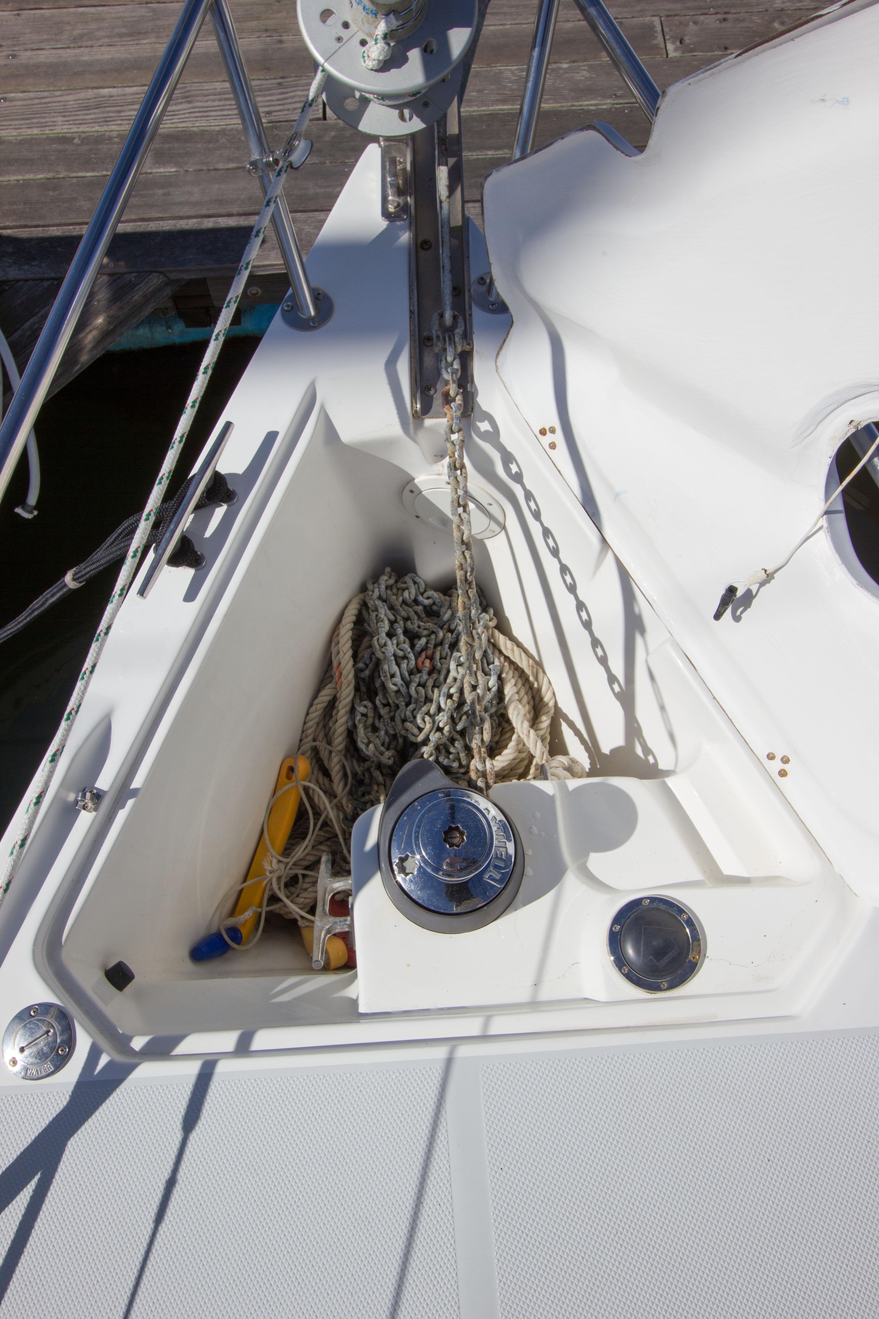 Anchor locker of 2001 Catalina MK II sailboat with ropes and winch.