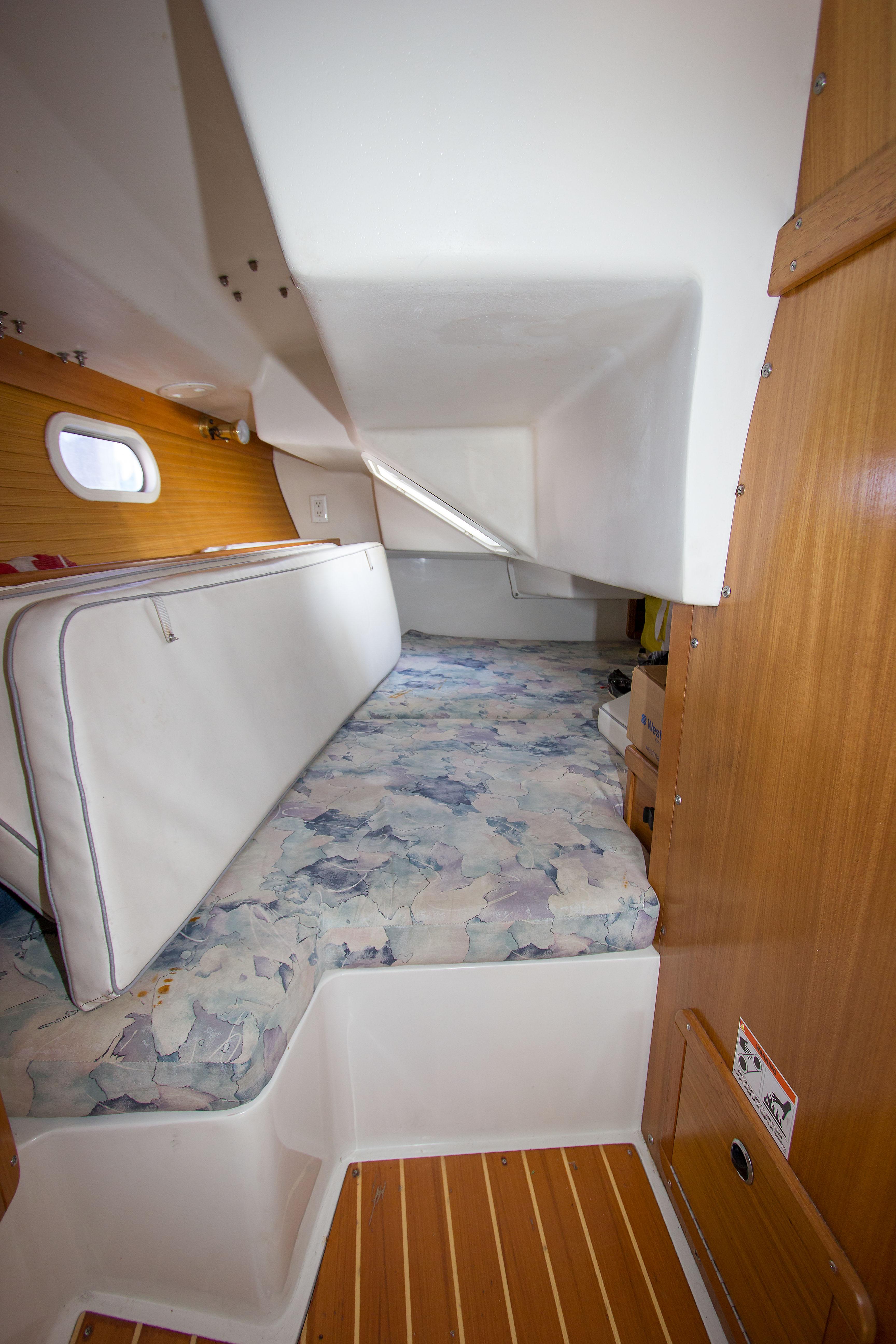Interior cabin of a 2001 Catalina MK II sailboat with wooden accents and cushioned seating.