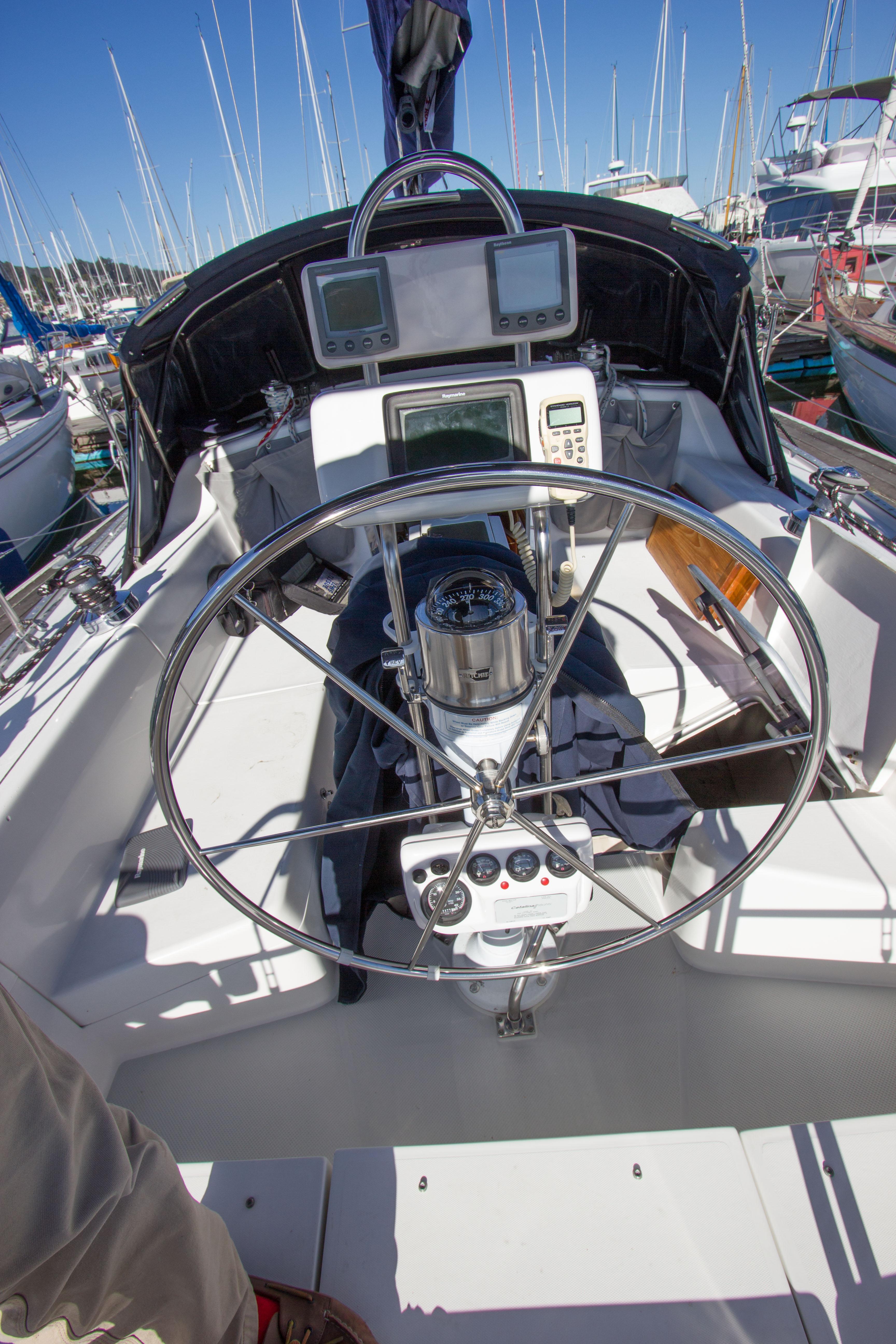2001 Catalina MK II sailboat cockpit with steering wheel and navigation instruments.