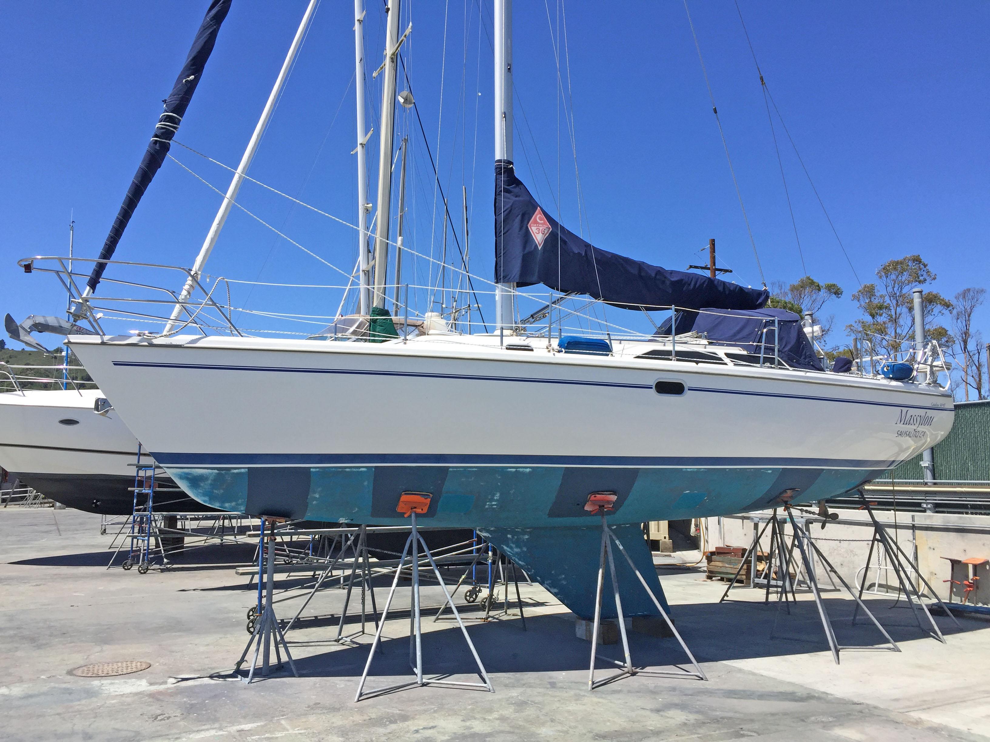 Catalina MK II 2001 sailboat on stands in a boatyard under clear blue sky.