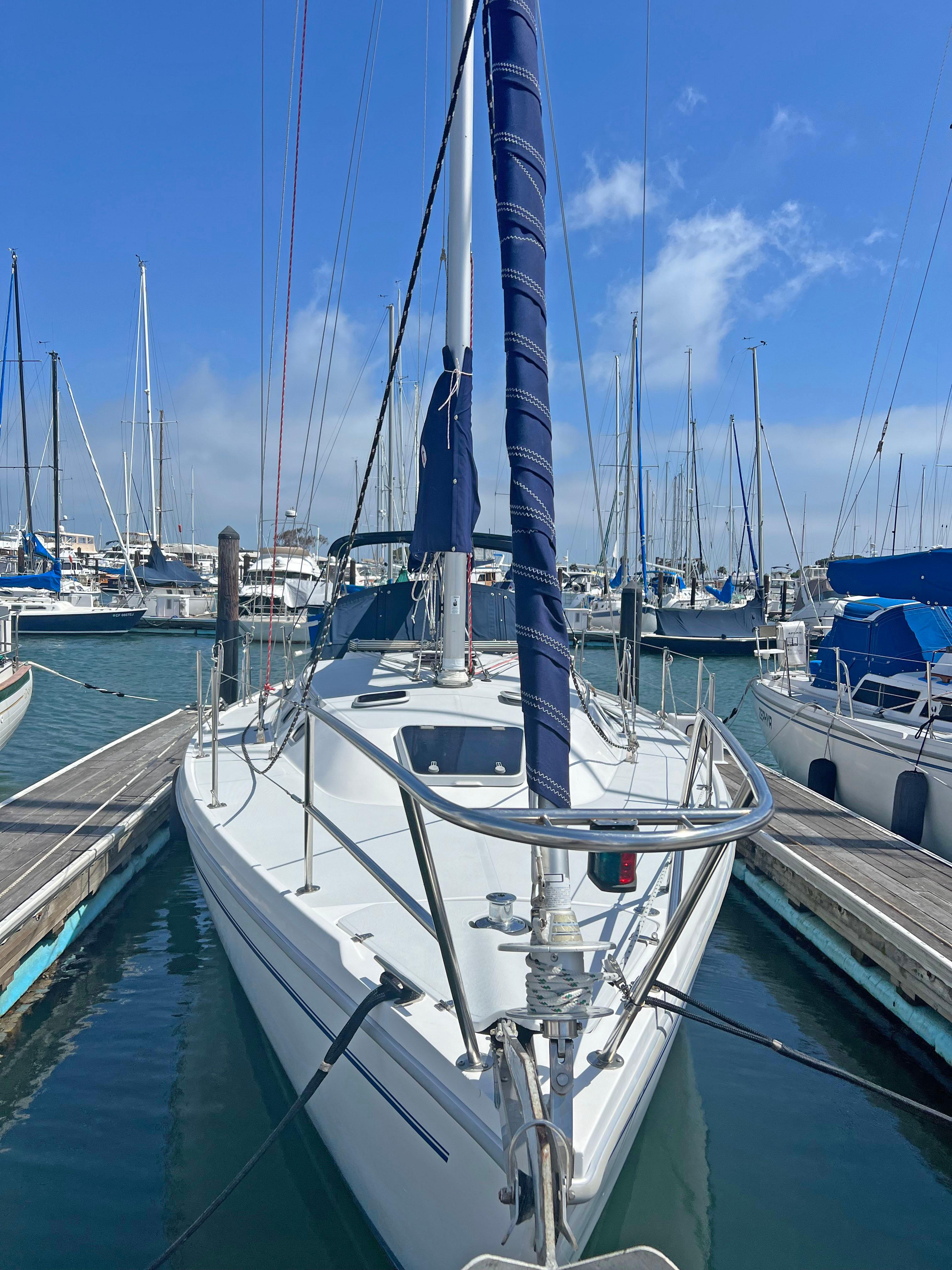 2001 Catalina MK II sailboat docked in a marina under a clear blue sky.