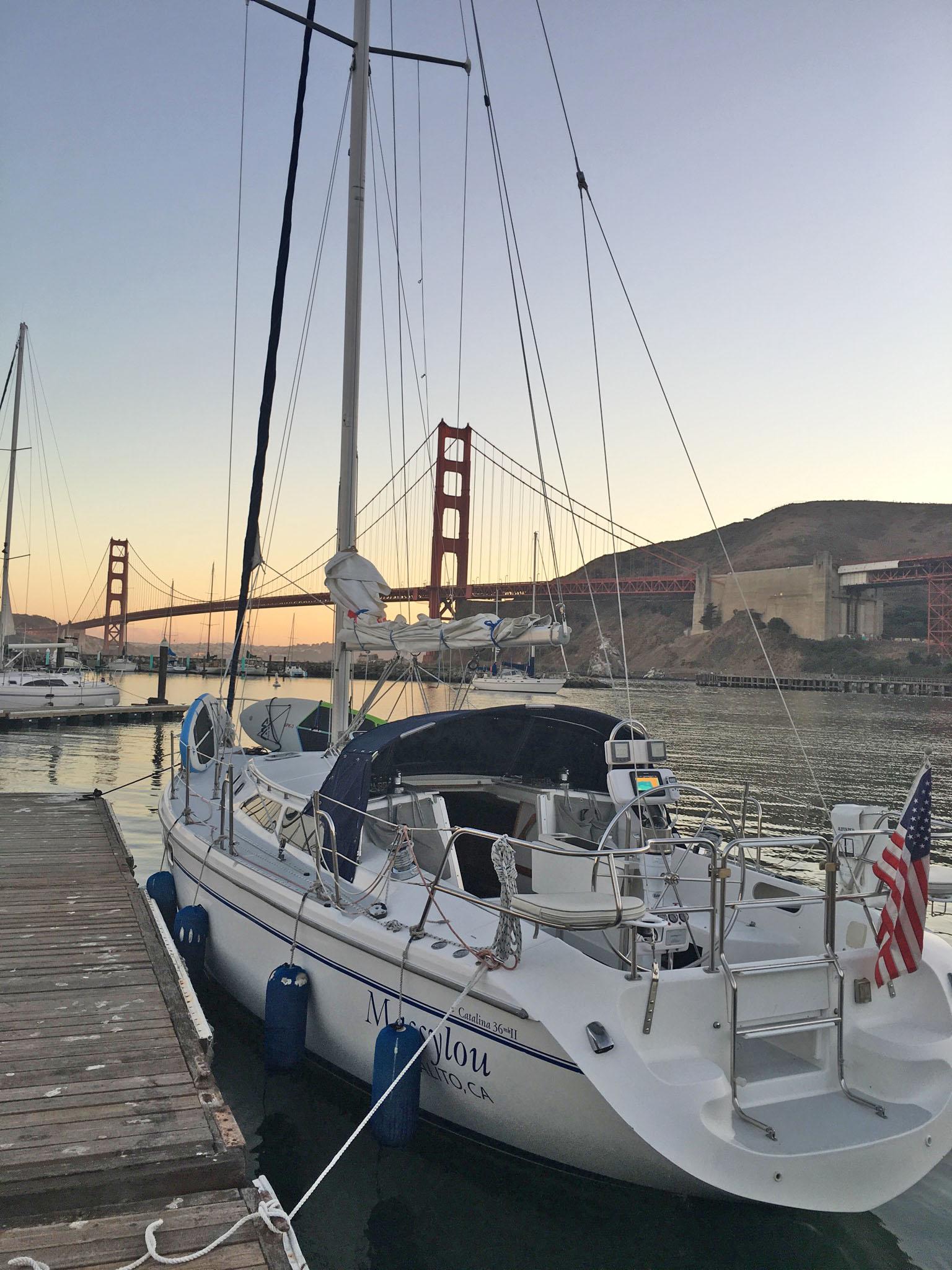 Catalina MK II 2001 sailboat docked near Golden Gate Bridge at sunset.