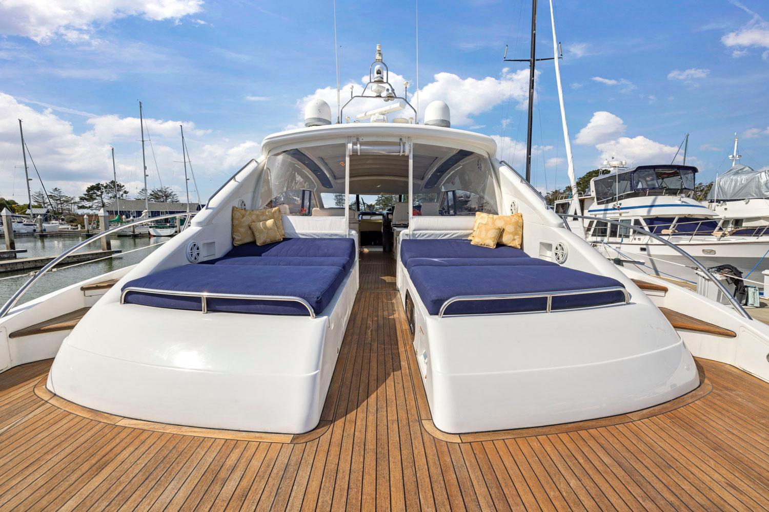 Princess-65 2003-DISMISSED CA-US-Luxury 2003 Princess 65 yacht with spacious deck and blue sunbeds in marina.-8801006 | Thumbnail