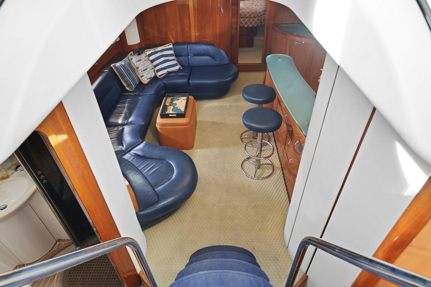 Princess-65 2003-DISMISSED CA-US-Luxurious interior of 2003 Princess 65 yacht with blue leather seating and bar stools.-8801006 | Thumbnail