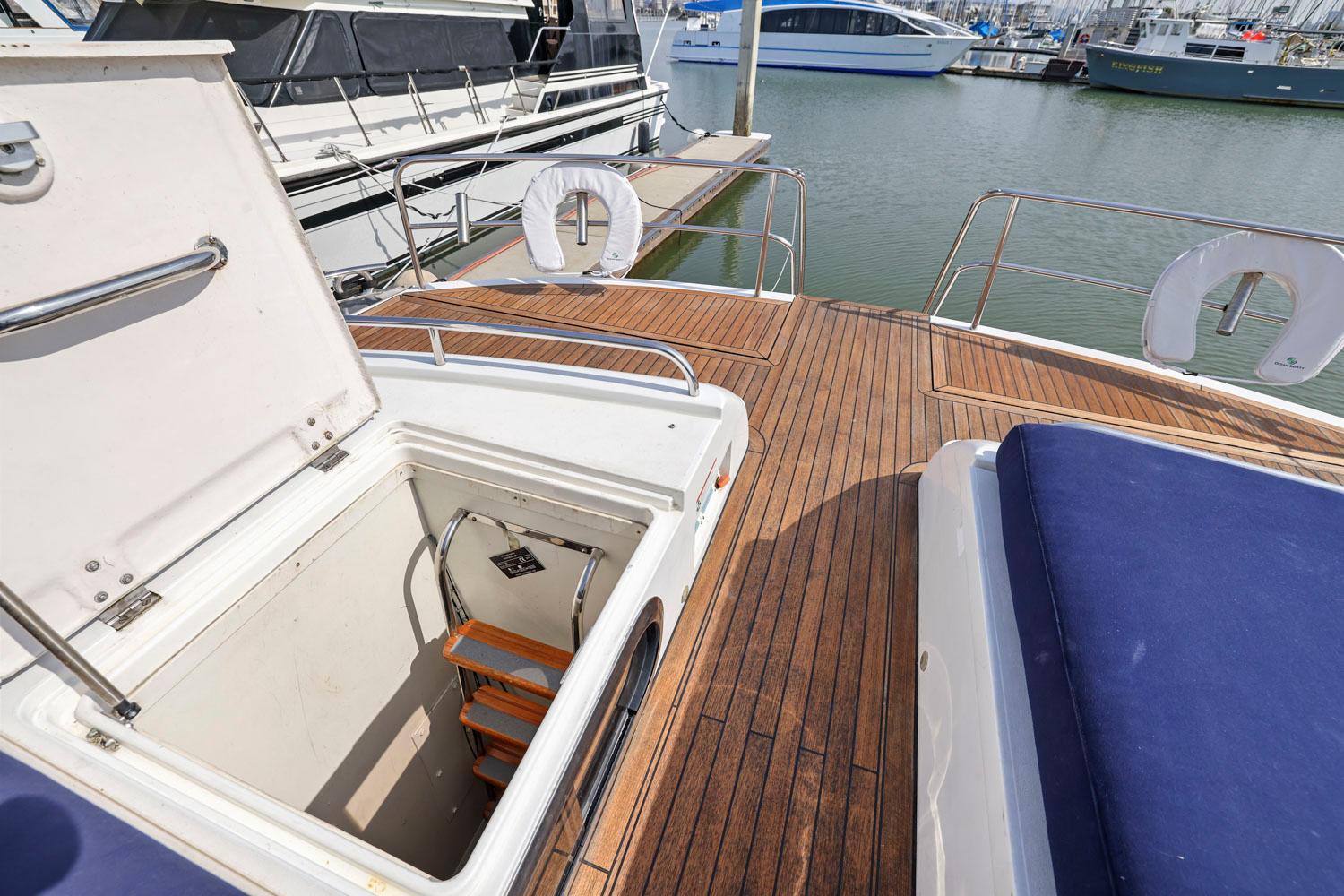 Princess-65 2003-DISMISSED CA-US-Deck of 2003 Princess 65 yacht with open hatch and wooden flooring.-8801006 | Thumbnail