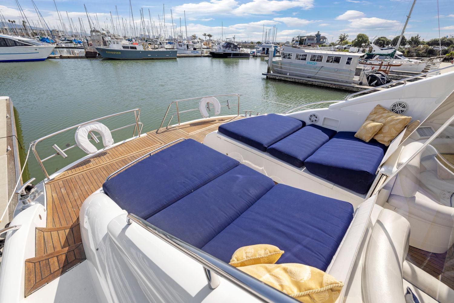 Princess-65 2003-DISMISSED CA-US-Luxurious 2003 Princess 65 yacht with blue sunbeds docked at a marina.-8801006 | Thumbnail