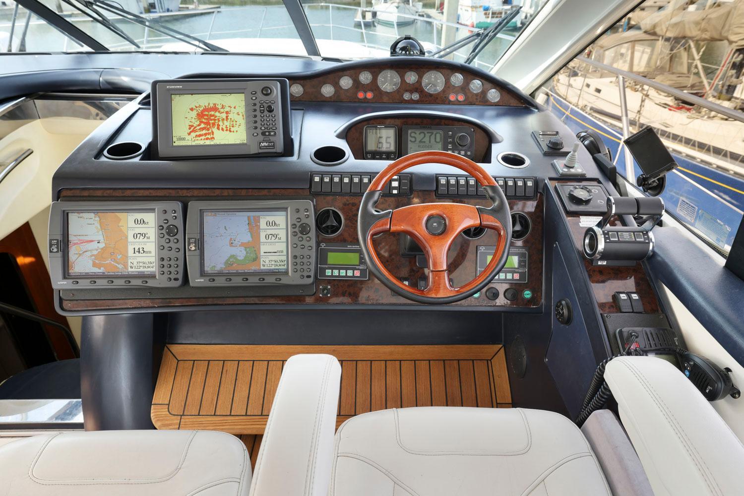 Princess-65 2003-DISMISSED CA-US-Cockpit of 2003 Princess 65 yacht with navigation equipment and wooden steering wheel.-8801006 | Thumbnail