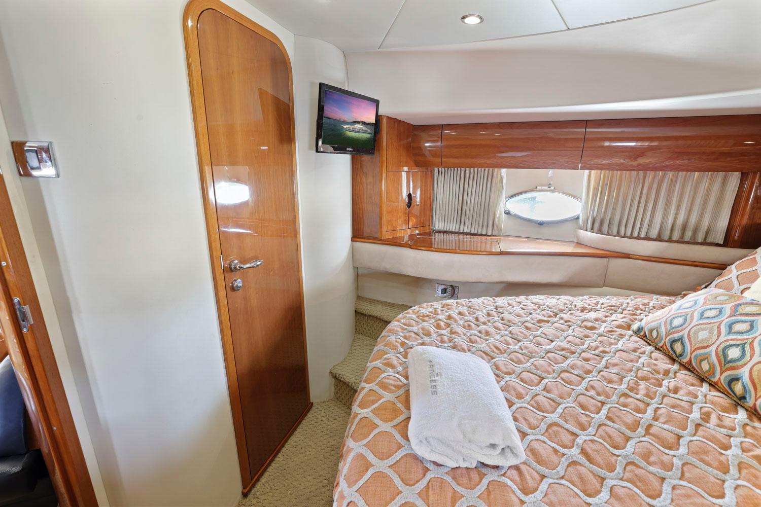 Princess-65 2003-DISMISSED CA-US-Luxurious cabin interior of 2003 Princess 65 yacht with cozy bed and TV.-8801006 | Thumbnail