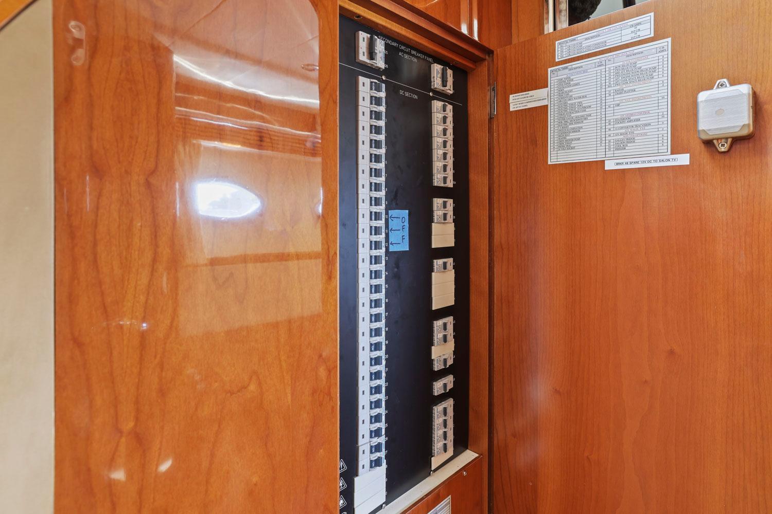 Princess-65 2003-DISMISSED CA-US-Electrical panel inside a 2003 Princess 65 yacht, featuring wooden cabinetry.-8801006 | Thumbnail