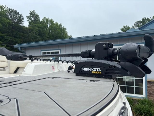 2021 Stingray 212 SC boat with Minn Kota Terrova trolling motor, parked near a building.
