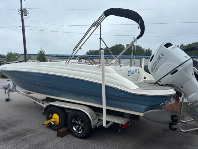 2021 Stingray 212 SC boat on trailer with Suzuki outboard motor.