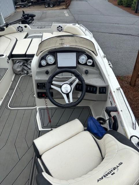 2021 Stingray 212 SC boat interior with steering wheel and dashboard controls.