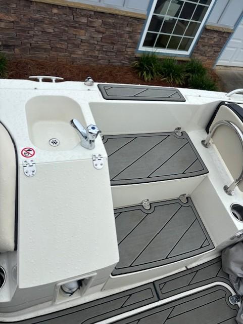 2021 Stingray 212 SC boat interior with sink and seating area.