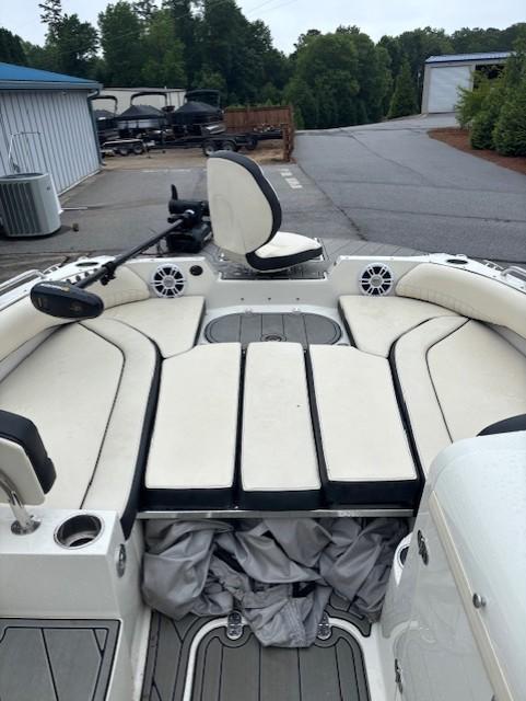 2021 Stingray 212 SC boat with spacious seating and modern design in a marina setting.