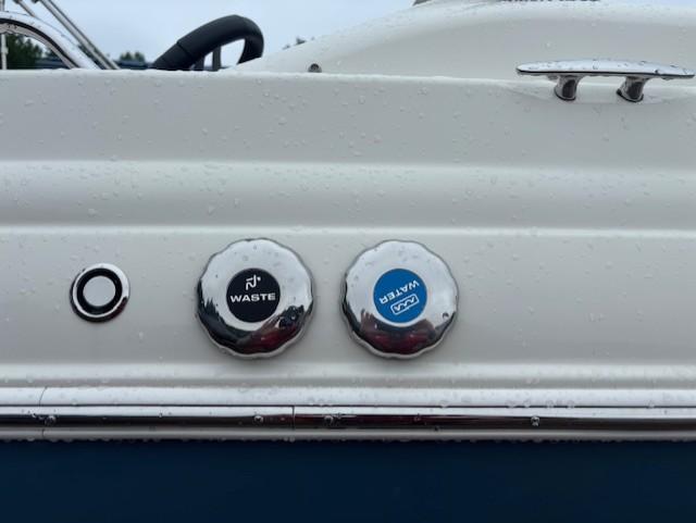 2021 Stingray 212 SC boat waste and water caps on a white surface.