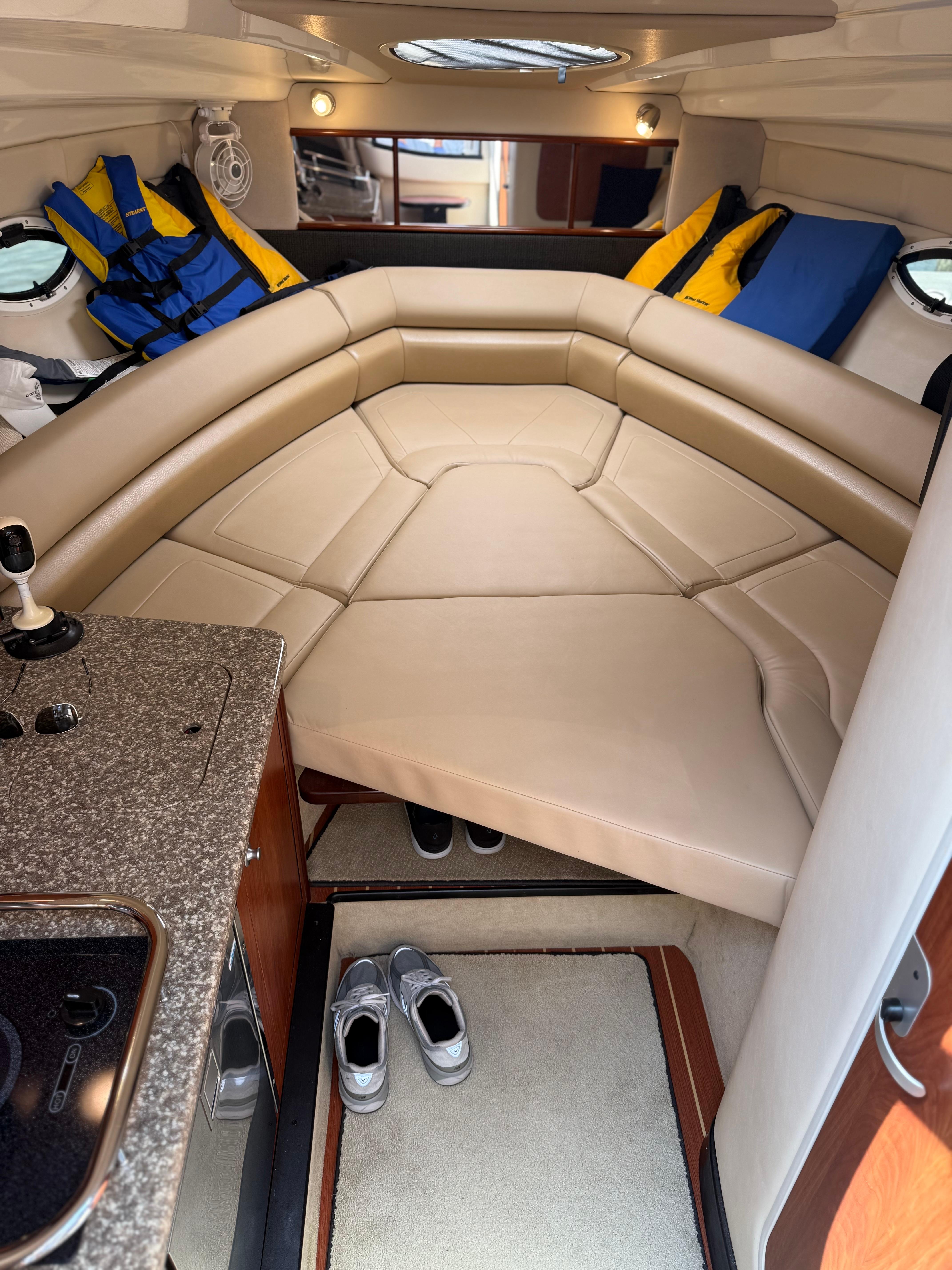 Interior of 2009 Monterey 280 SCR boat with beige seating and life jackets.