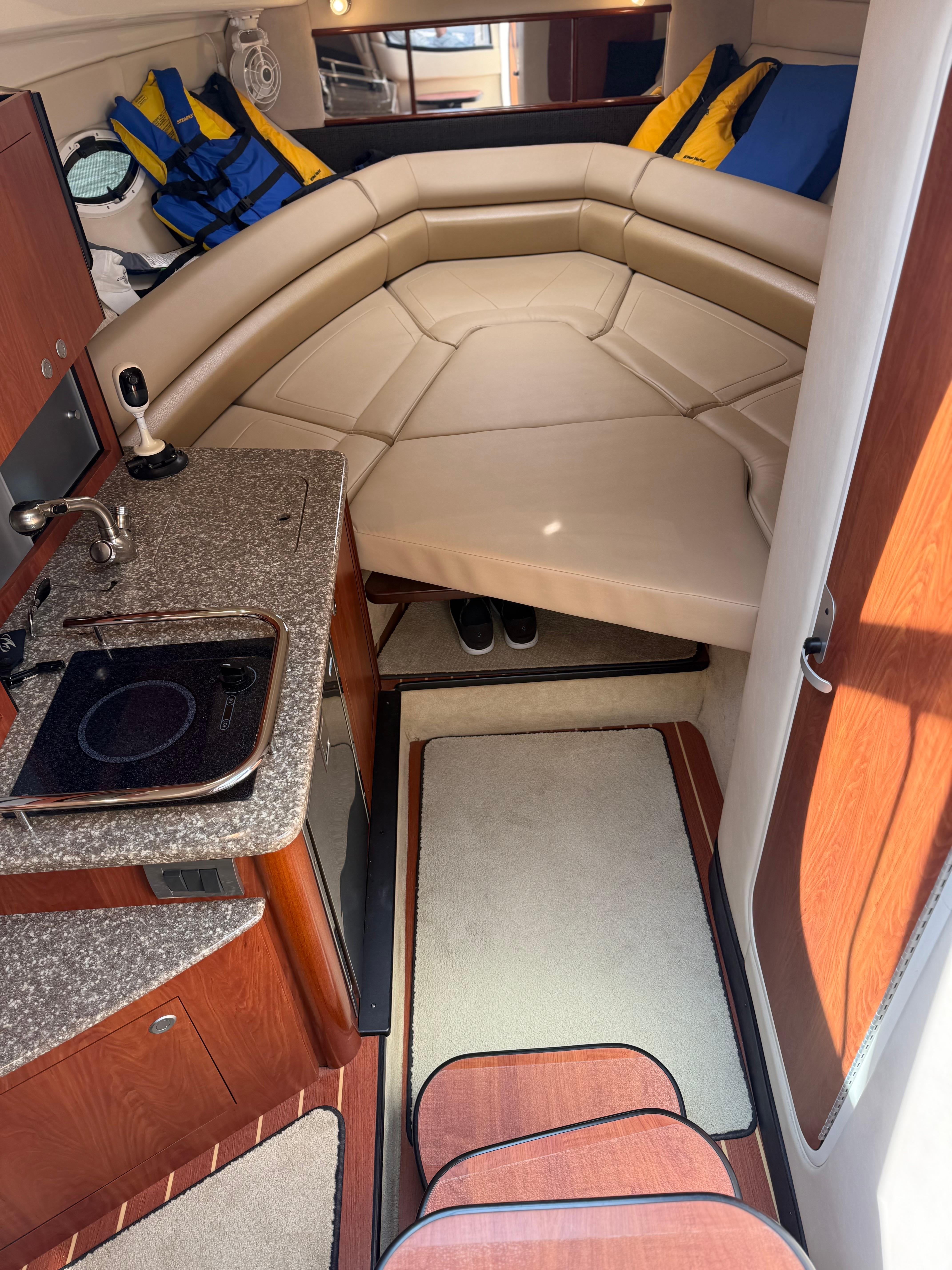 Interior of a 2009 Monterey 280 SCR boat with kitchenette and seating area.