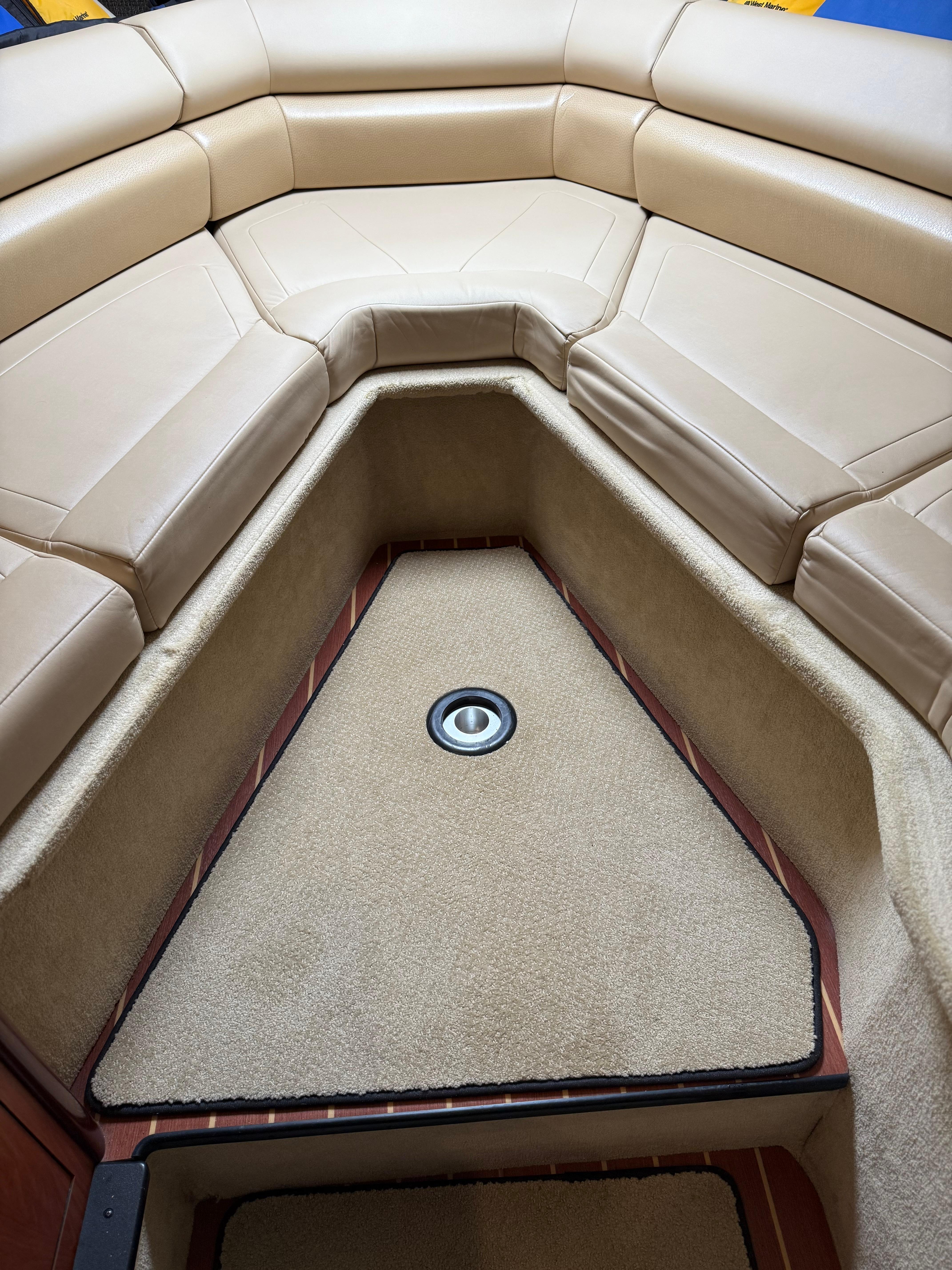 2009 Monterey 280 SCR boat interior with beige seating and carpeted flooring.