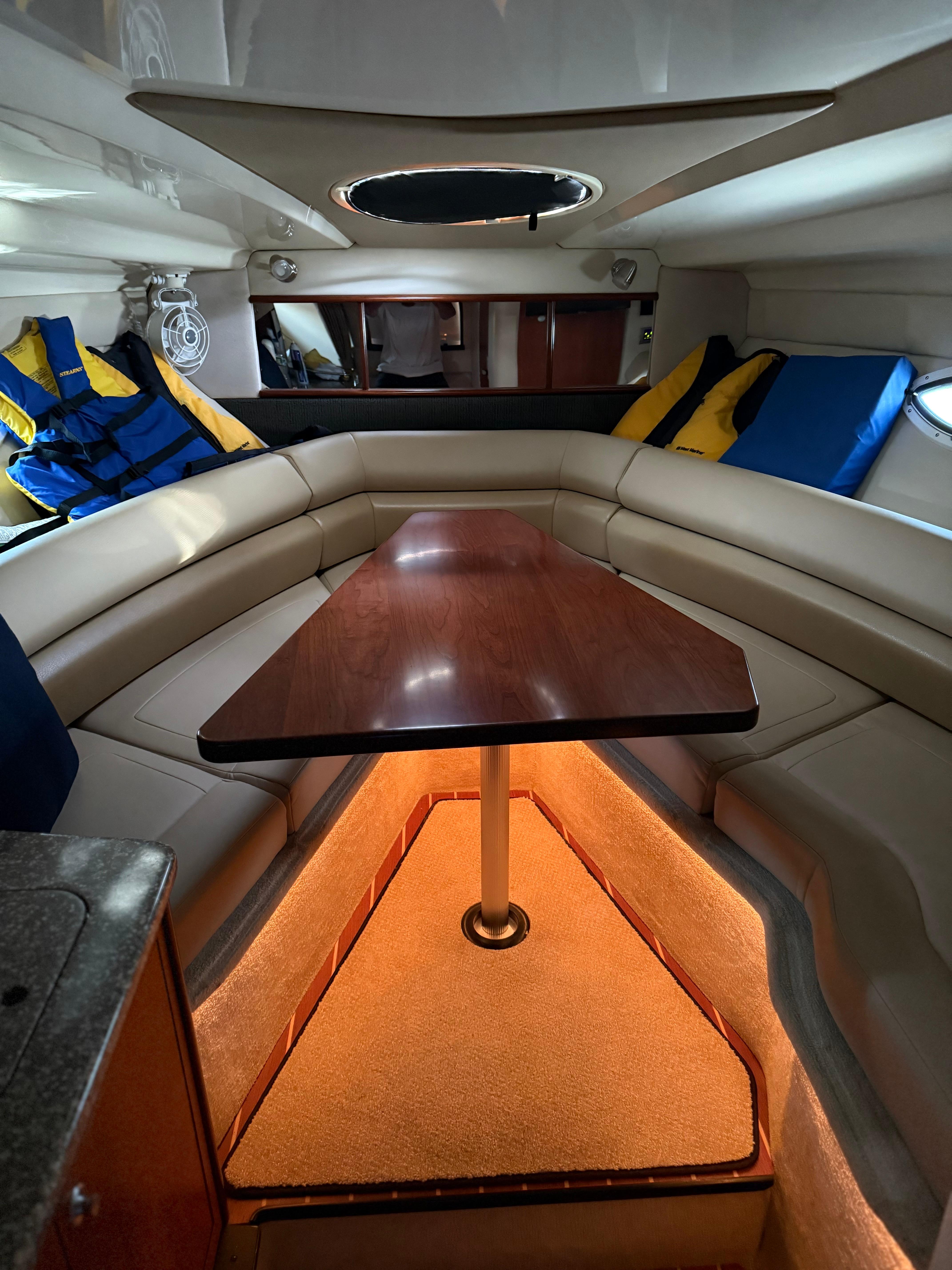 Luxurious interior of 2009 Monterey 280 SCR boat with cozy seating and table.