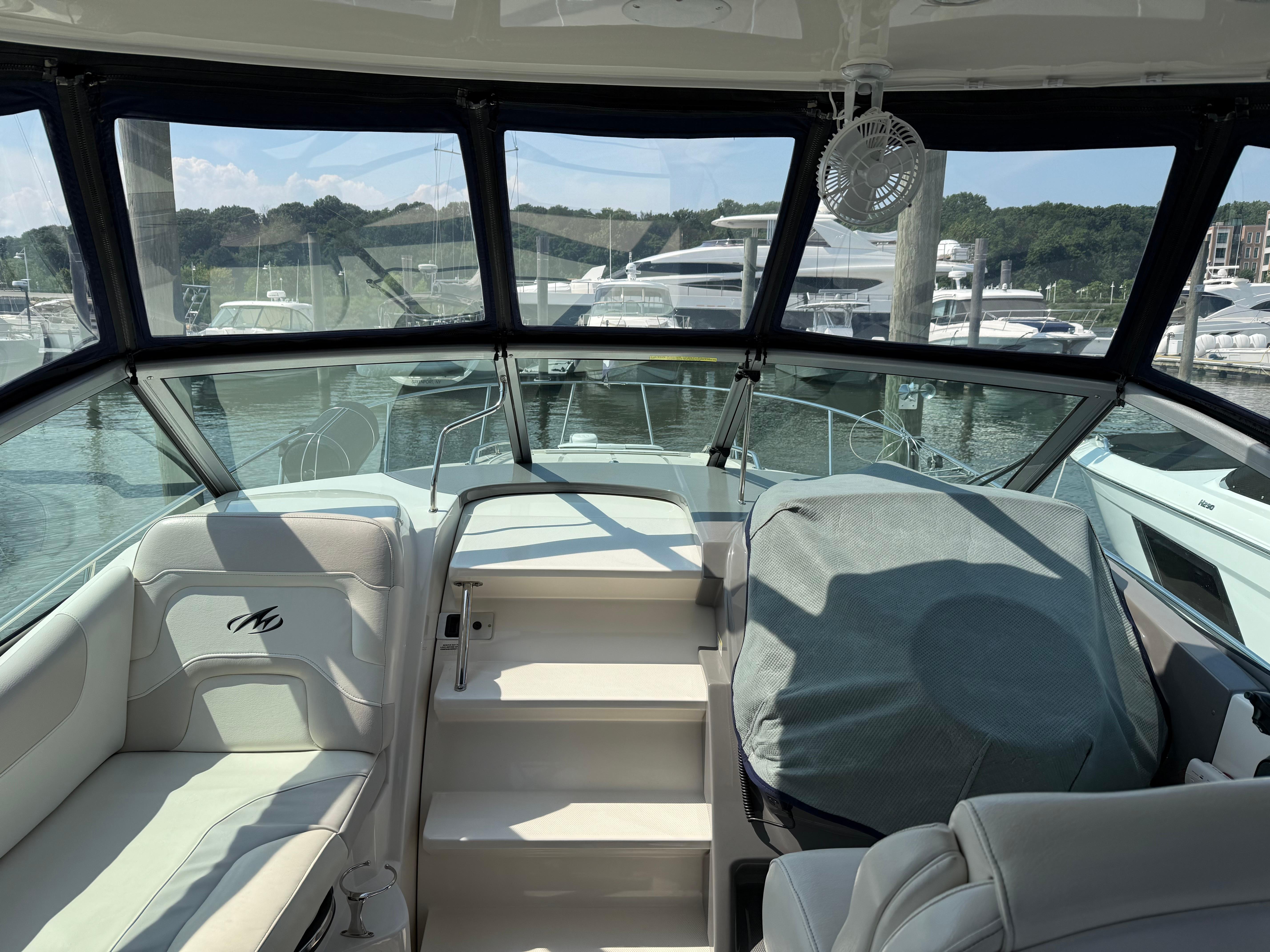 Interior view of a 2009 Monterey 280 SCR boat docked at a marina.