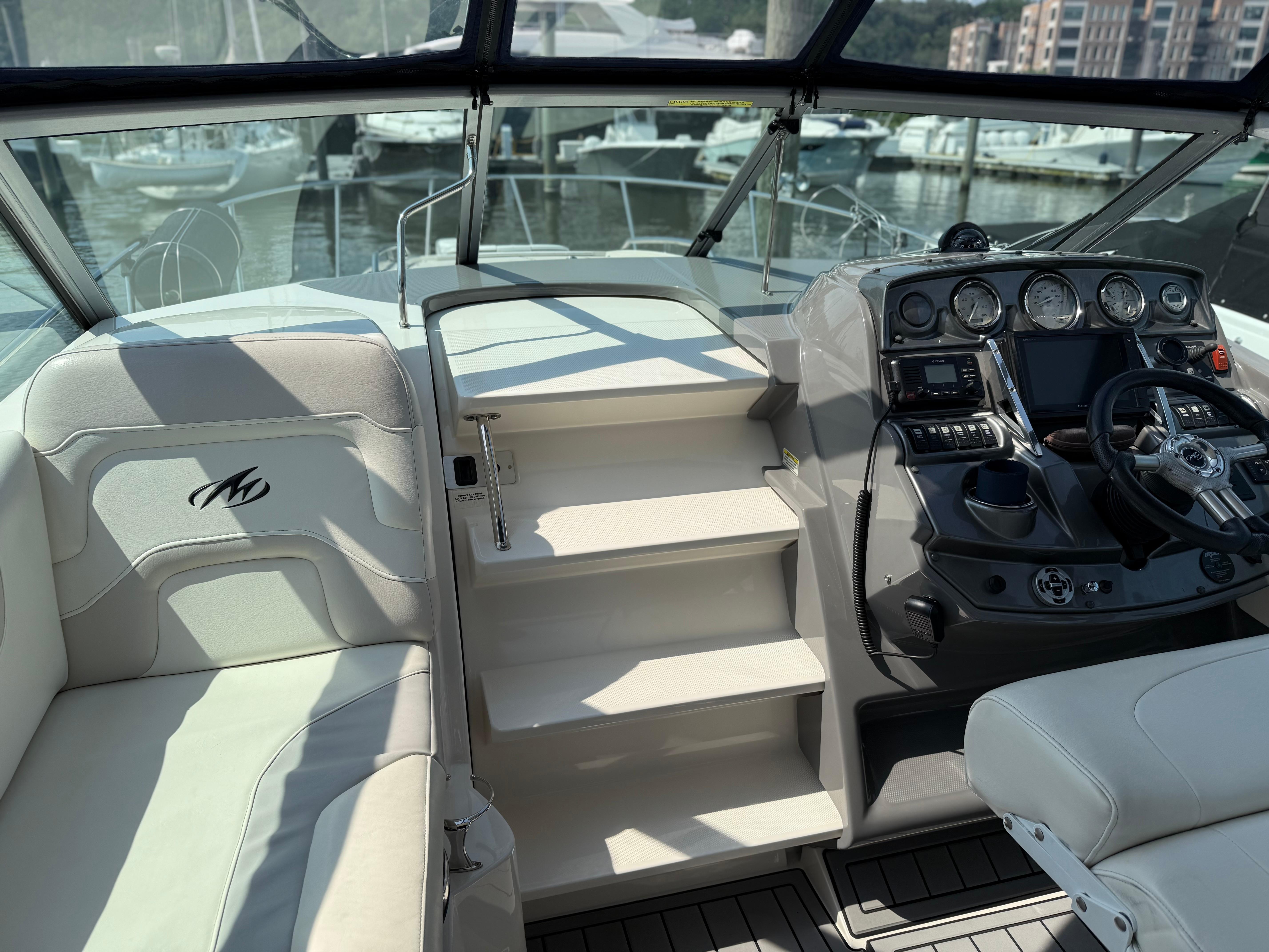 Interior of 2009 Monterey 280 SCR boat with helm and seating area.