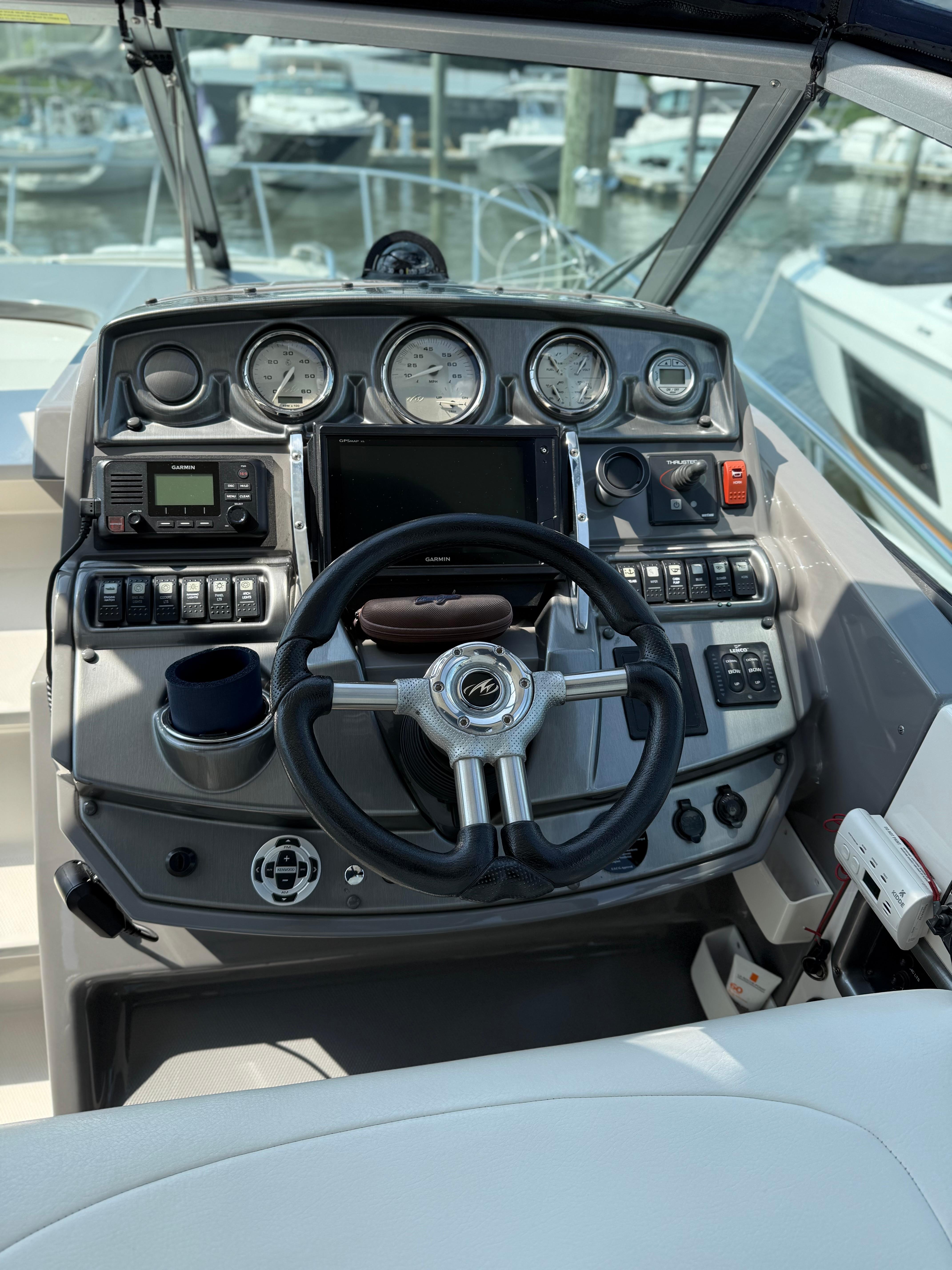 Dashboard of a 2009 Monterey 280 SCR boat with steering wheel and gauges.