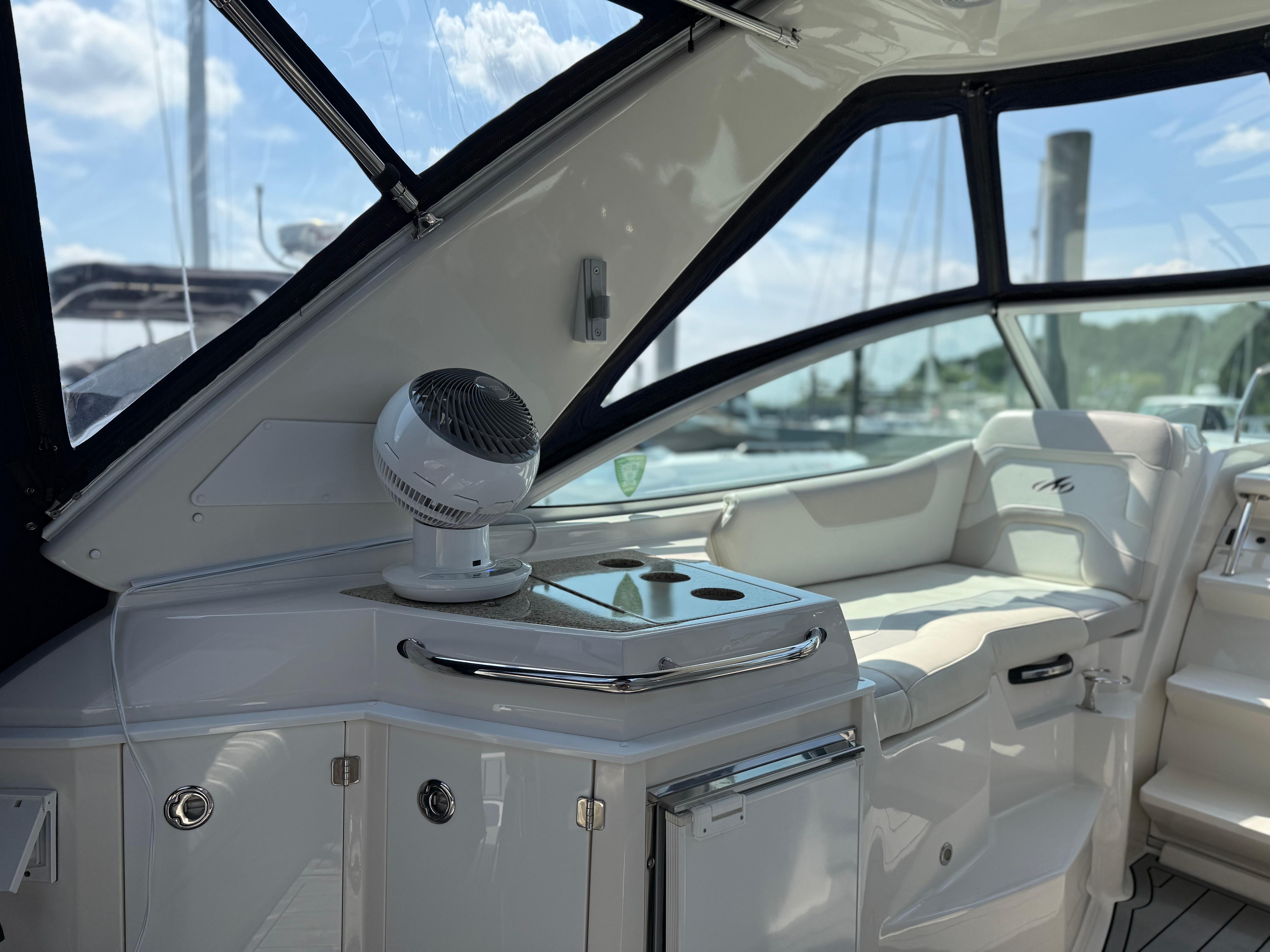 Interior of a 2009 Monterey 280 SCR boat, featuring seating and a compact kitchenette.