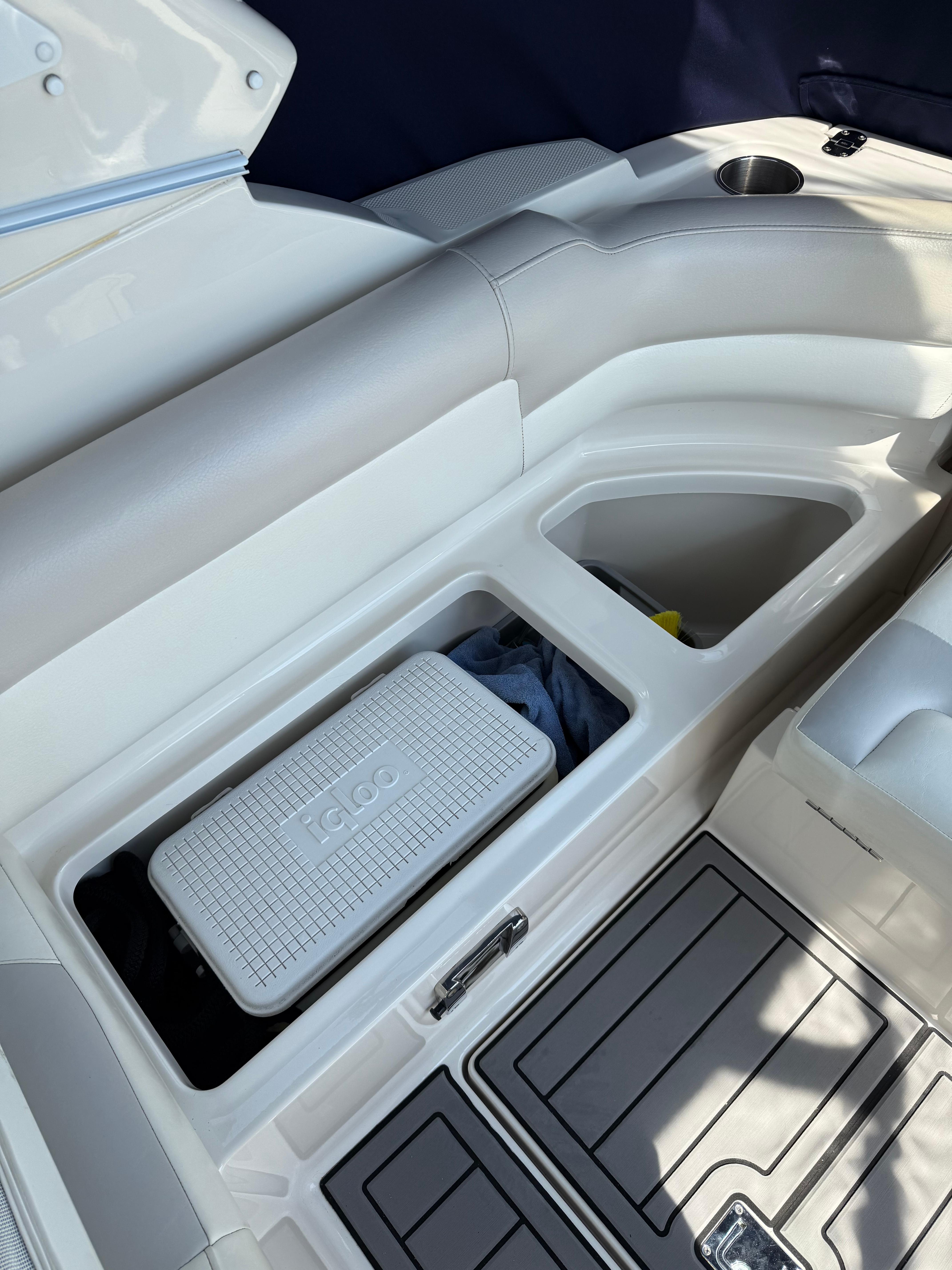 2009 Monterey 280 SCR boat interior with storage compartment and Igloo cooler.