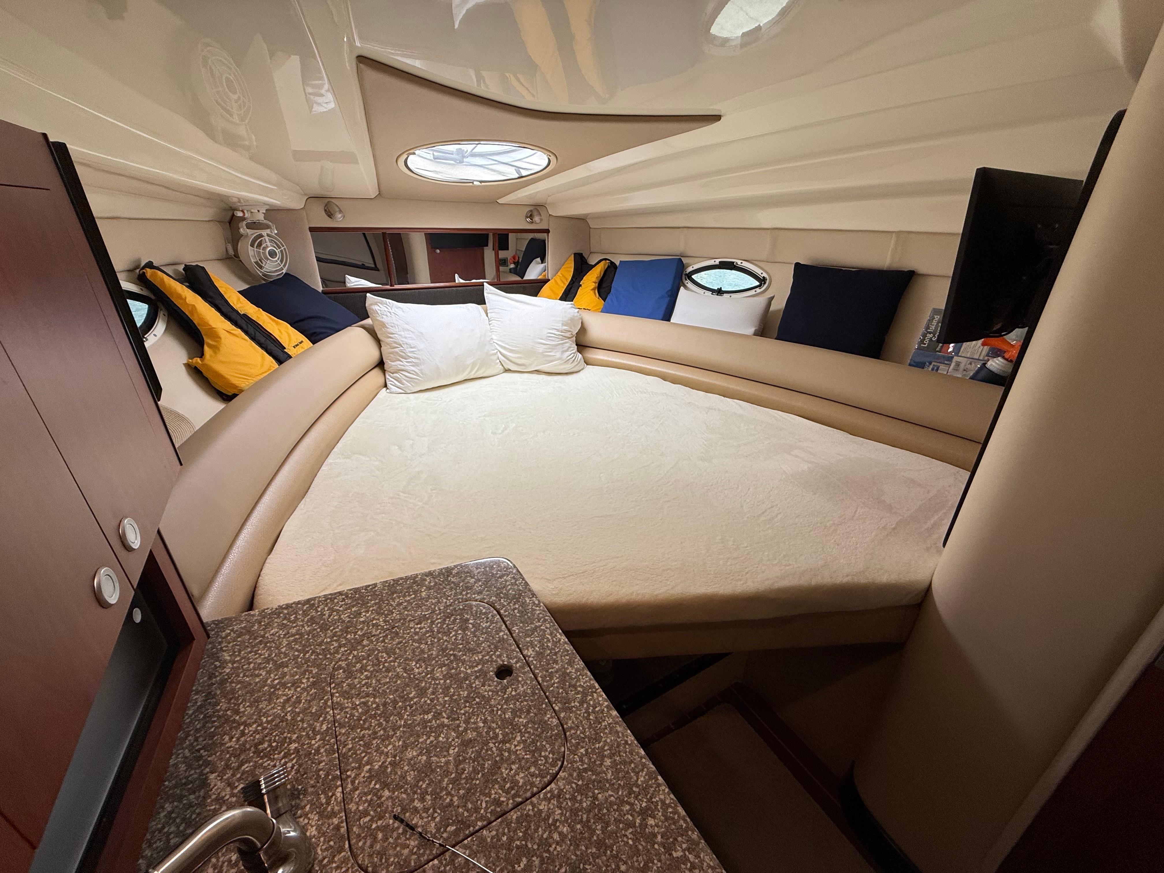 Interior of 2009 Monterey 280 SCR boat with cozy bed and modern amenities.