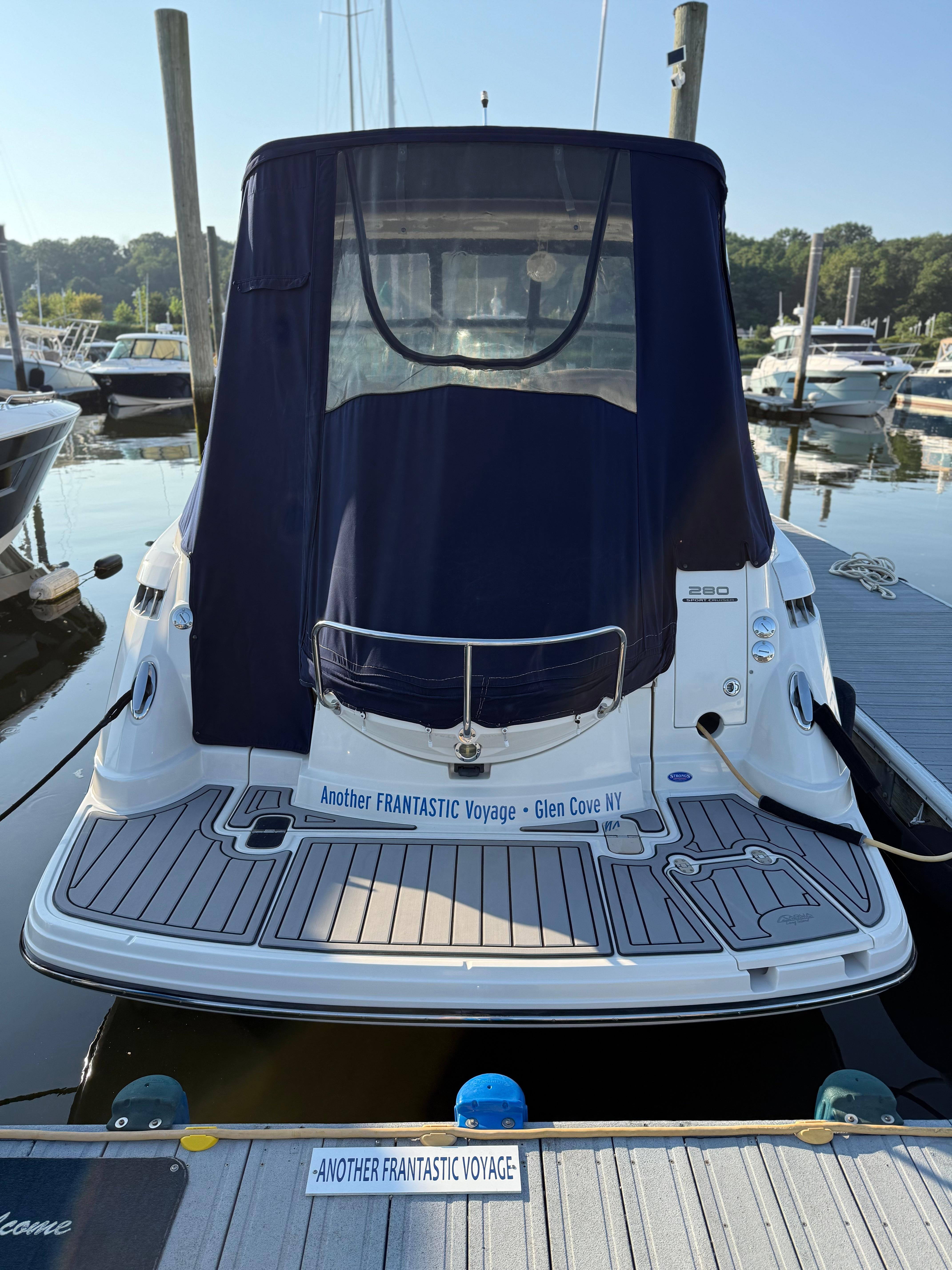 2009 Monterey 280 SCR boat docked at marina, rear view with cover.