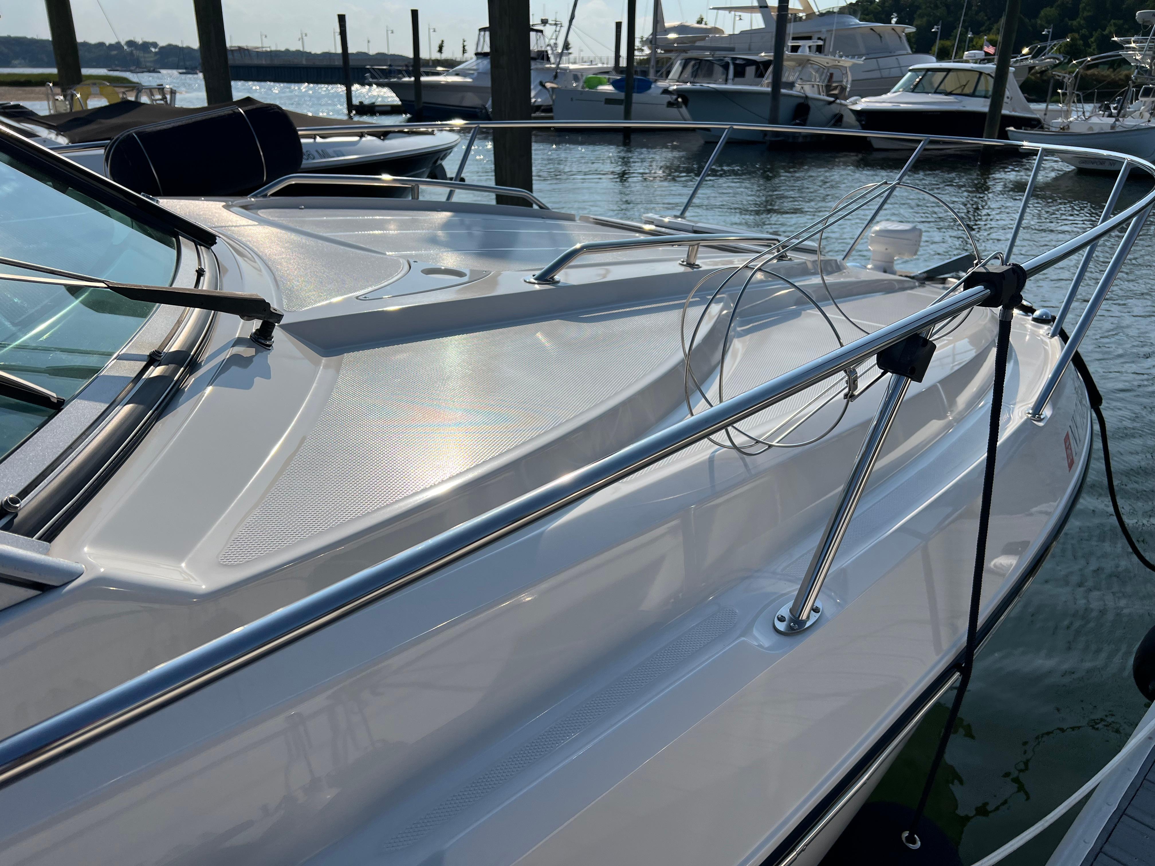 2009 Monterey 280 SCR boat docked at marina, featuring sleek design and stainless steel railings.