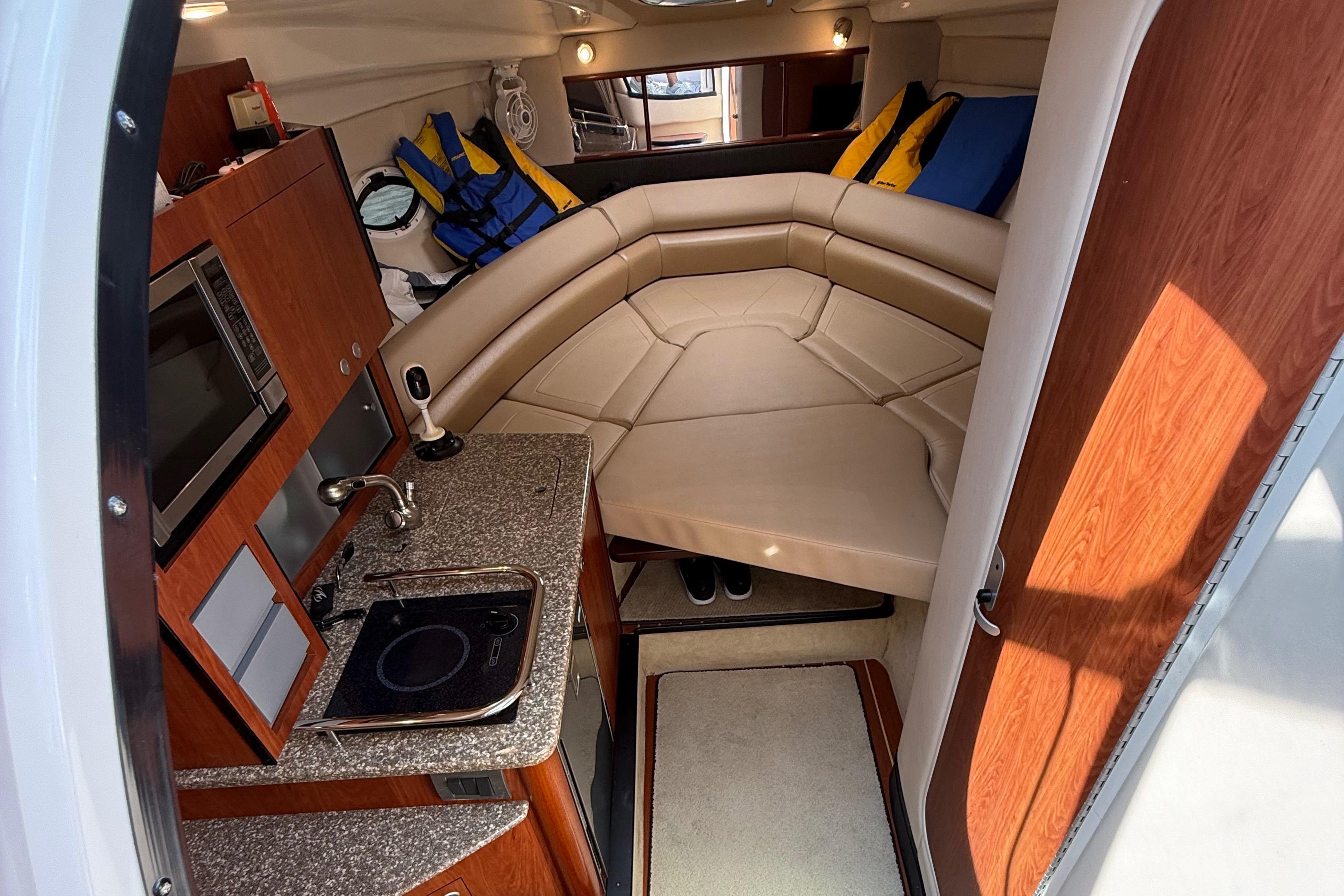 Interior of 2009 Monterey 280 SCR boat with kitchenette and seating area.