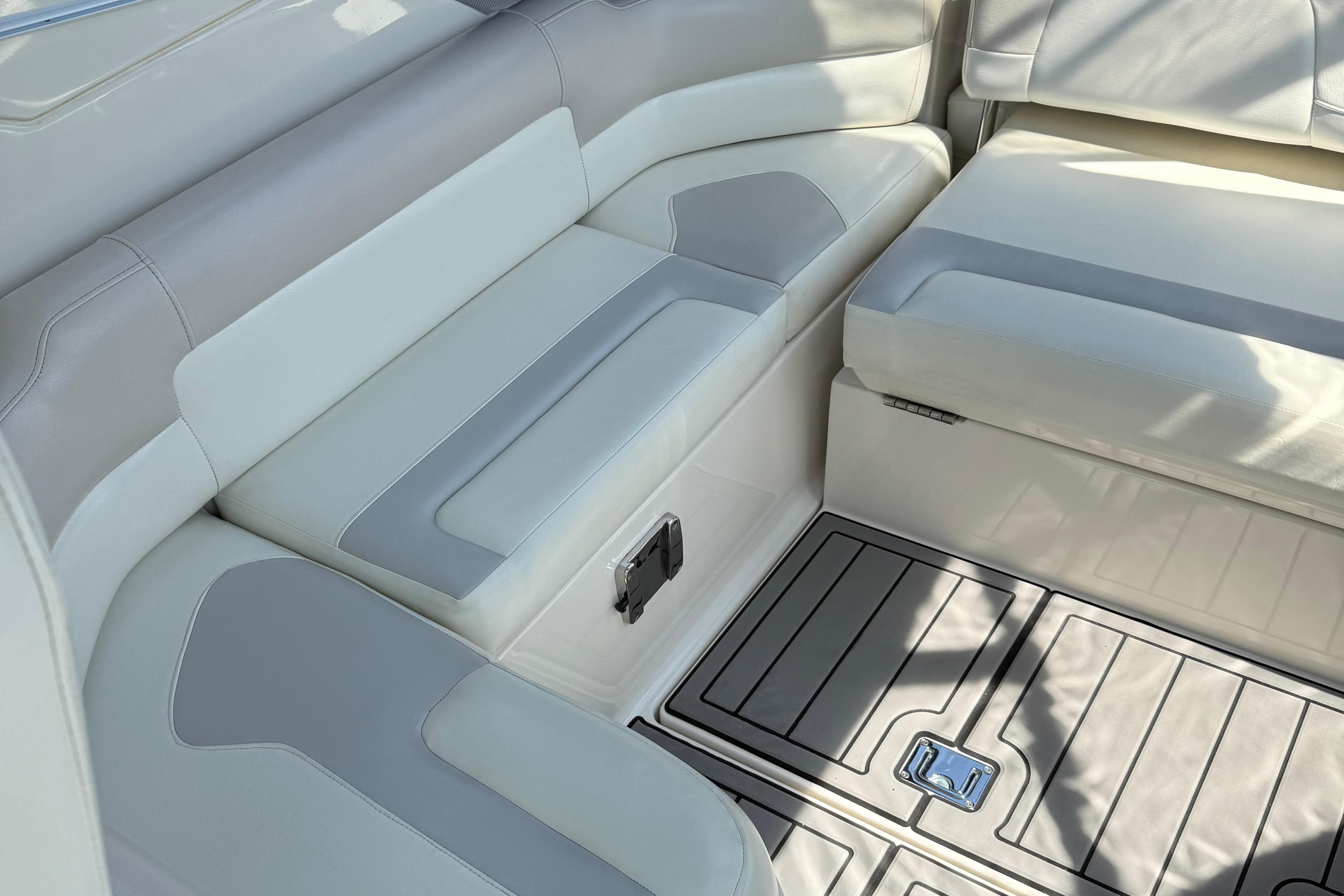 2009 Monterey 280 SCR boat interior with white and gray seating and deck flooring.