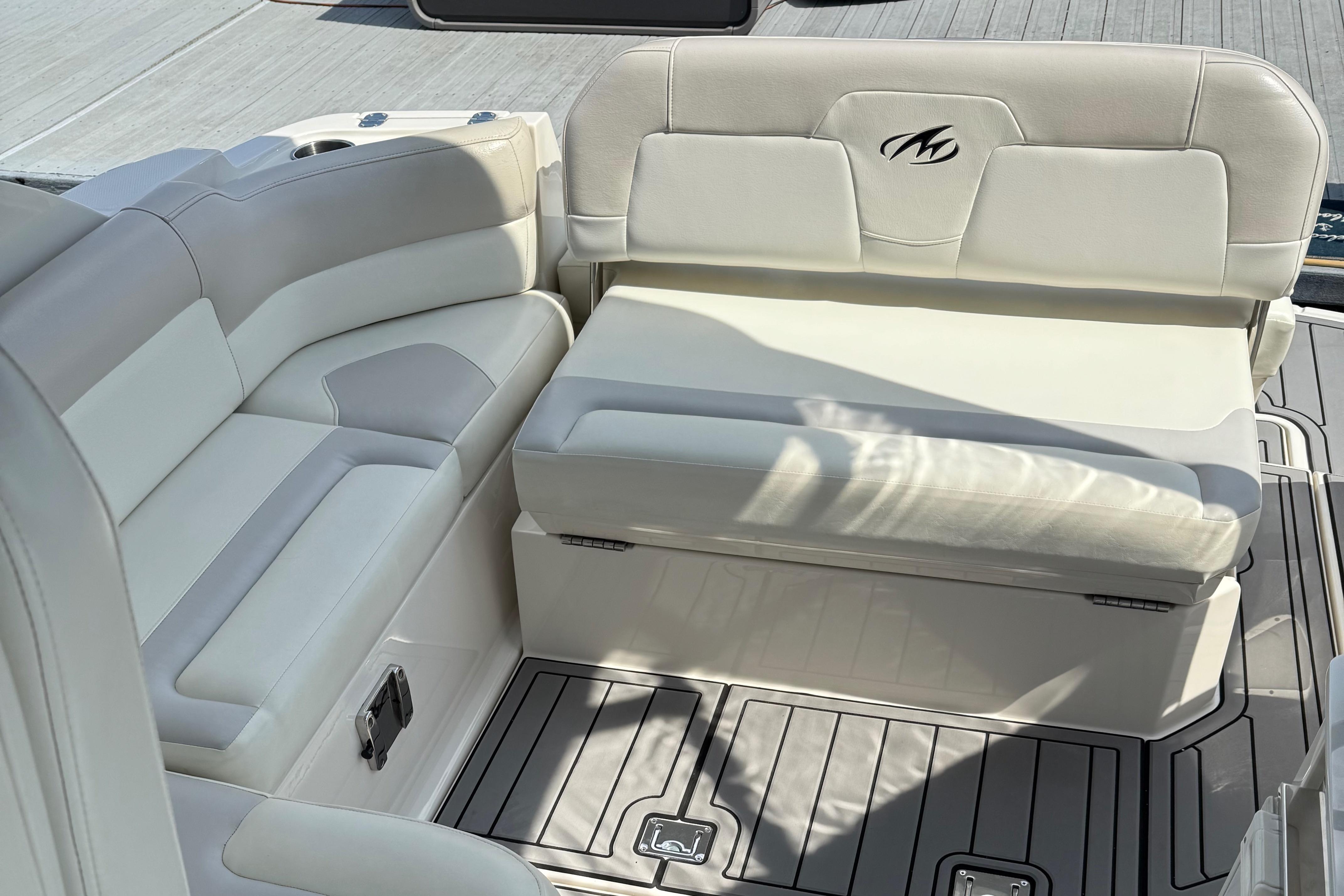 Luxury seating on a 2009 Monterey 280 SCR boat, featuring sleek white upholstery.