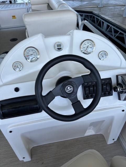 Steering console of a 2001 Monarch 240 boat with gauges and controls.