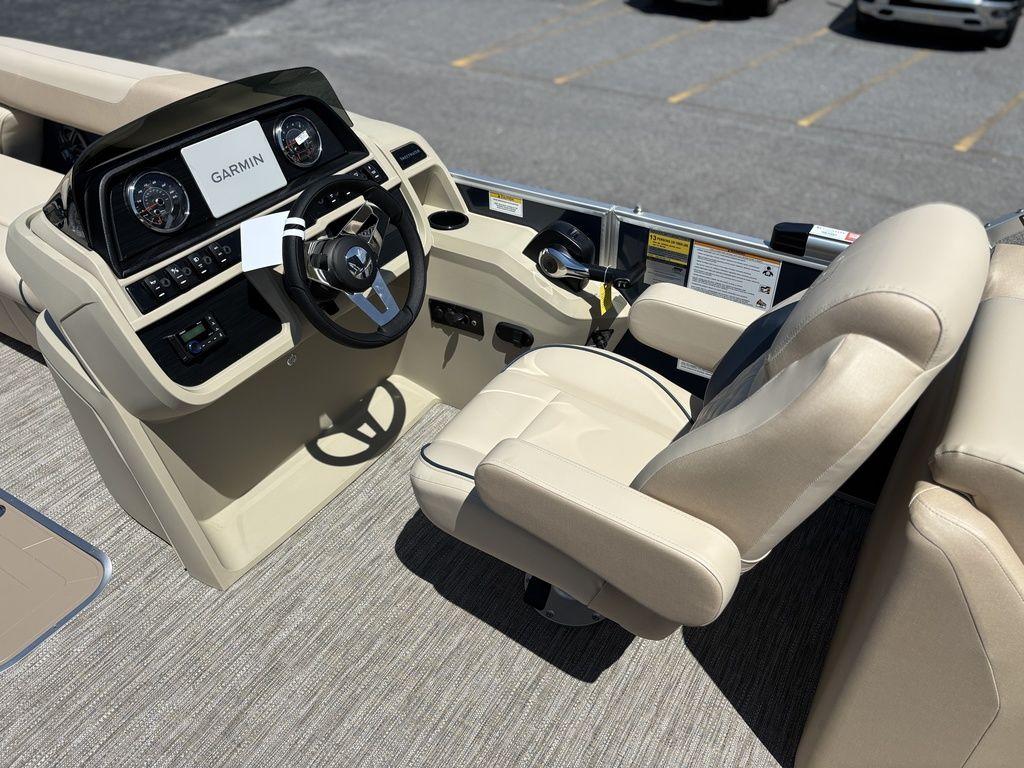 2025 Godfrey SWEETWATER 2286 SB boat interior with Garmin navigation system and beige seating.