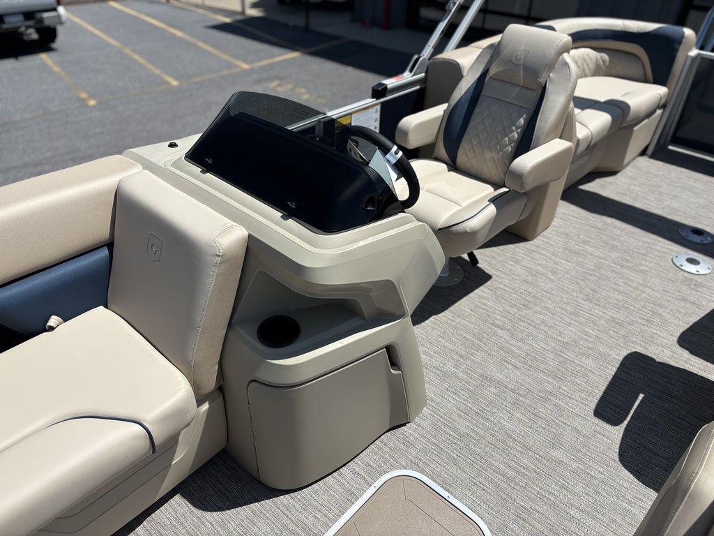 2025 Godfrey SWEETWATER 2286 SB boat interior with beige seating and steering console.