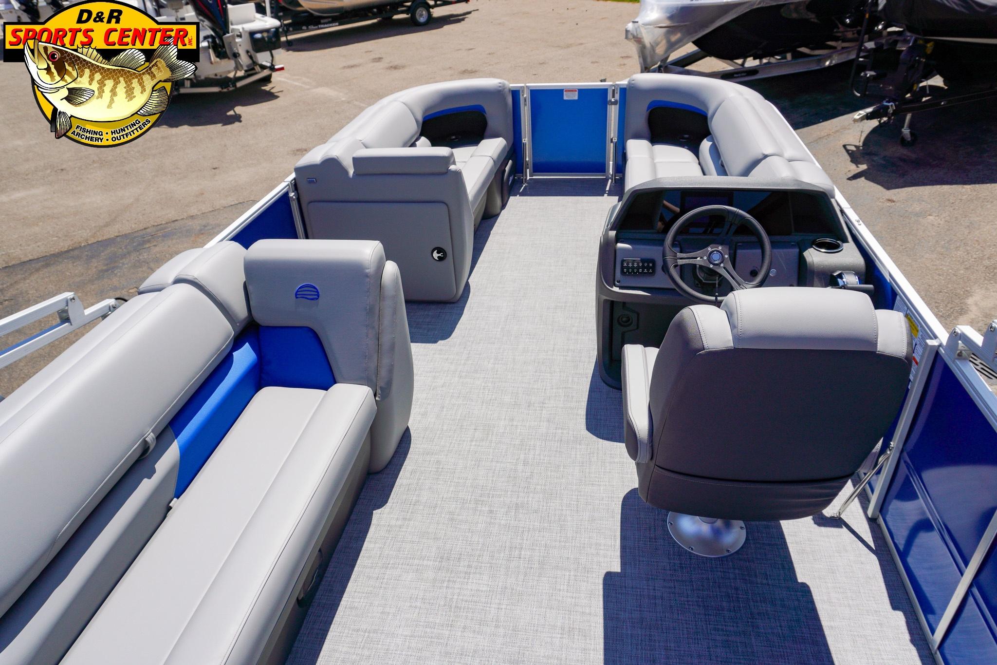 2026 Sun Tracker Party Barge 20 DLX interior with gray seating and steering console.