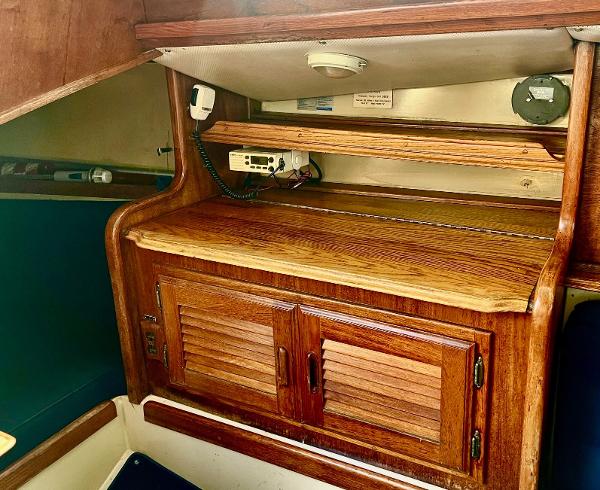 1978 Islander Sloop 36 interior with wooden cabinetry and radio equipment.