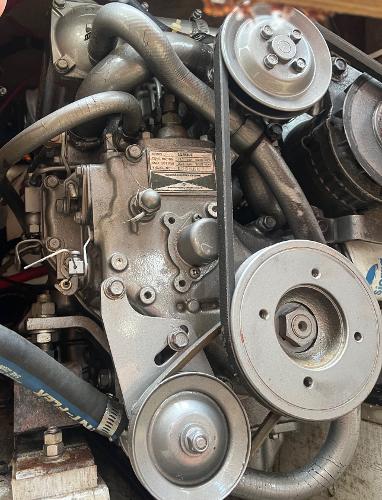 Engine of a 1978 Islander Sloop 36 sailboat, featuring belts and pulleys.