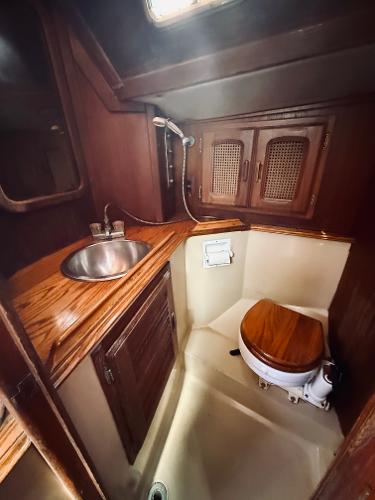 1978 Islander Sloop 36 yacht bathroom with wooden cabinetry and compact design.