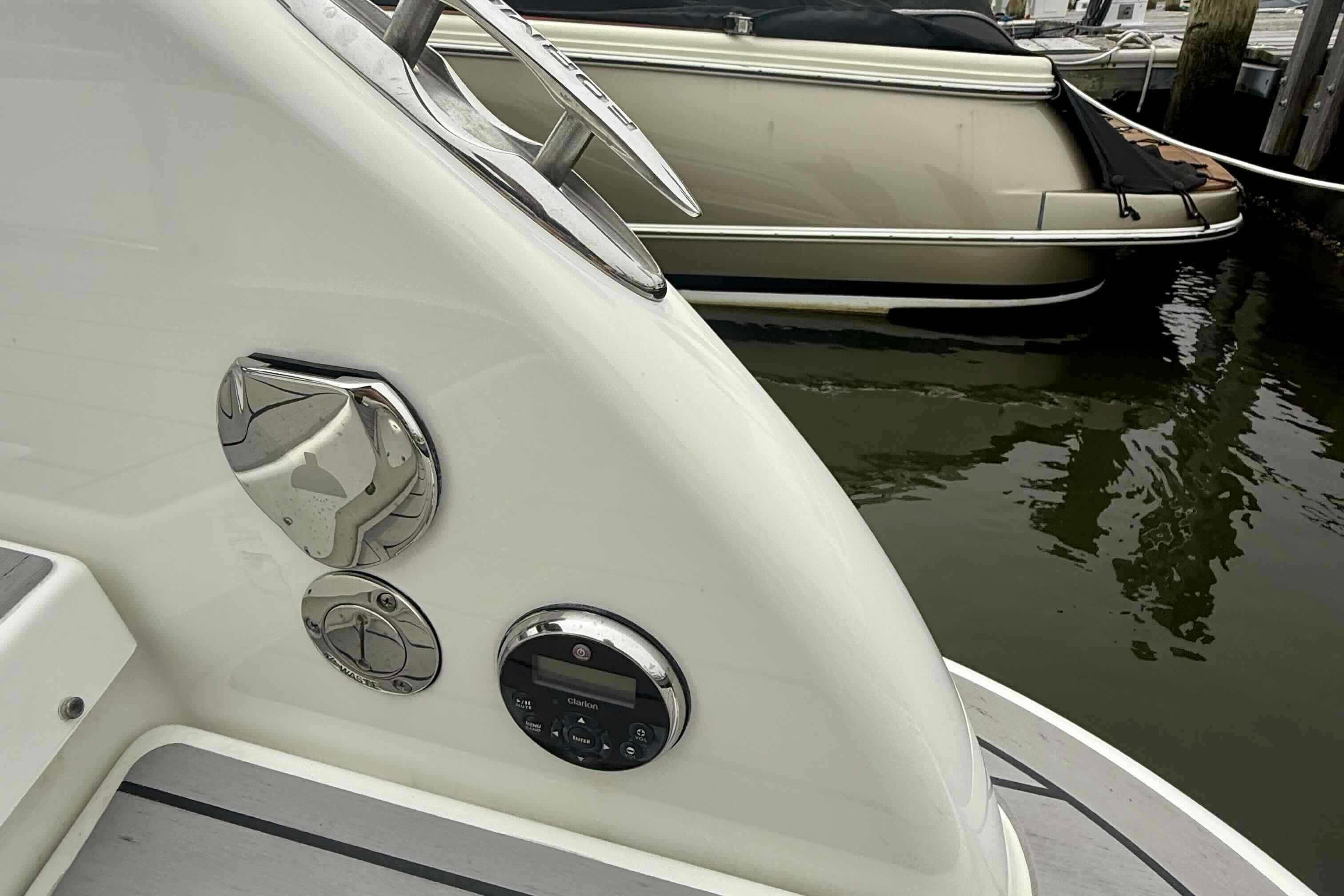 2020 Formula 290 Bowrider boat detail, docked near another vessel, showcasing sleek design.